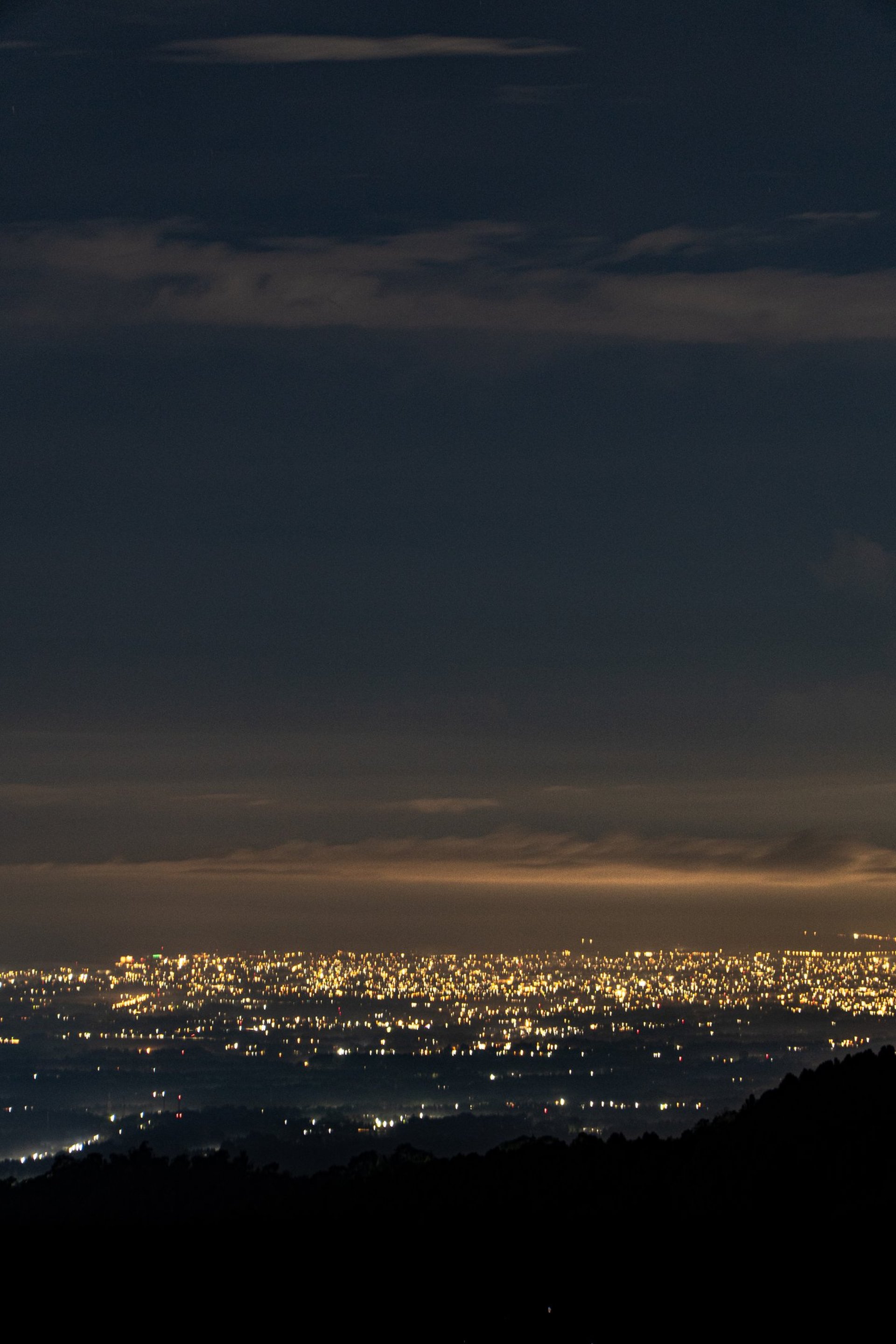 an abstract photo of a curved building with a blue sky in the background
