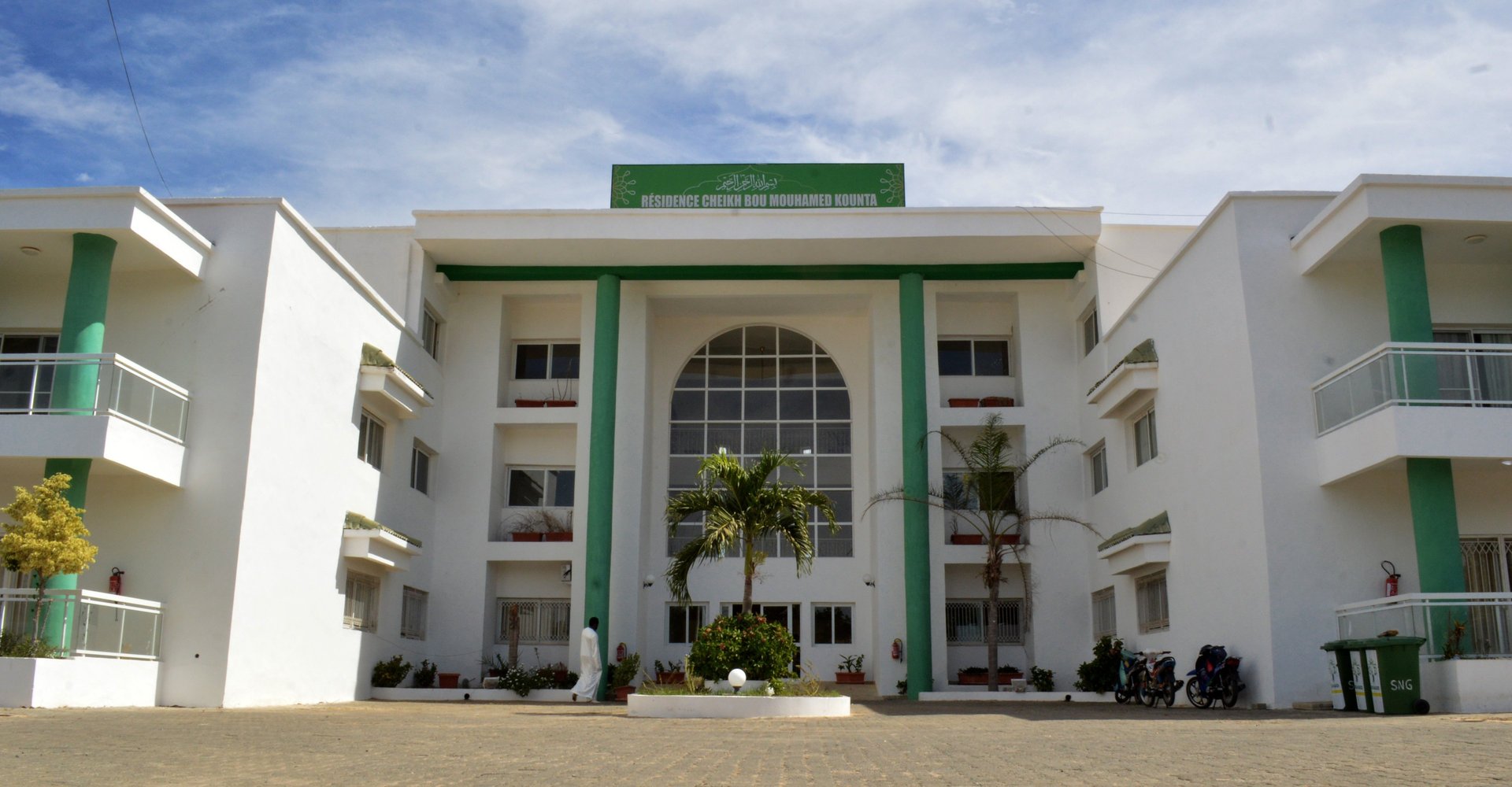 an abstract photo of a curved building with a blue sky in the background