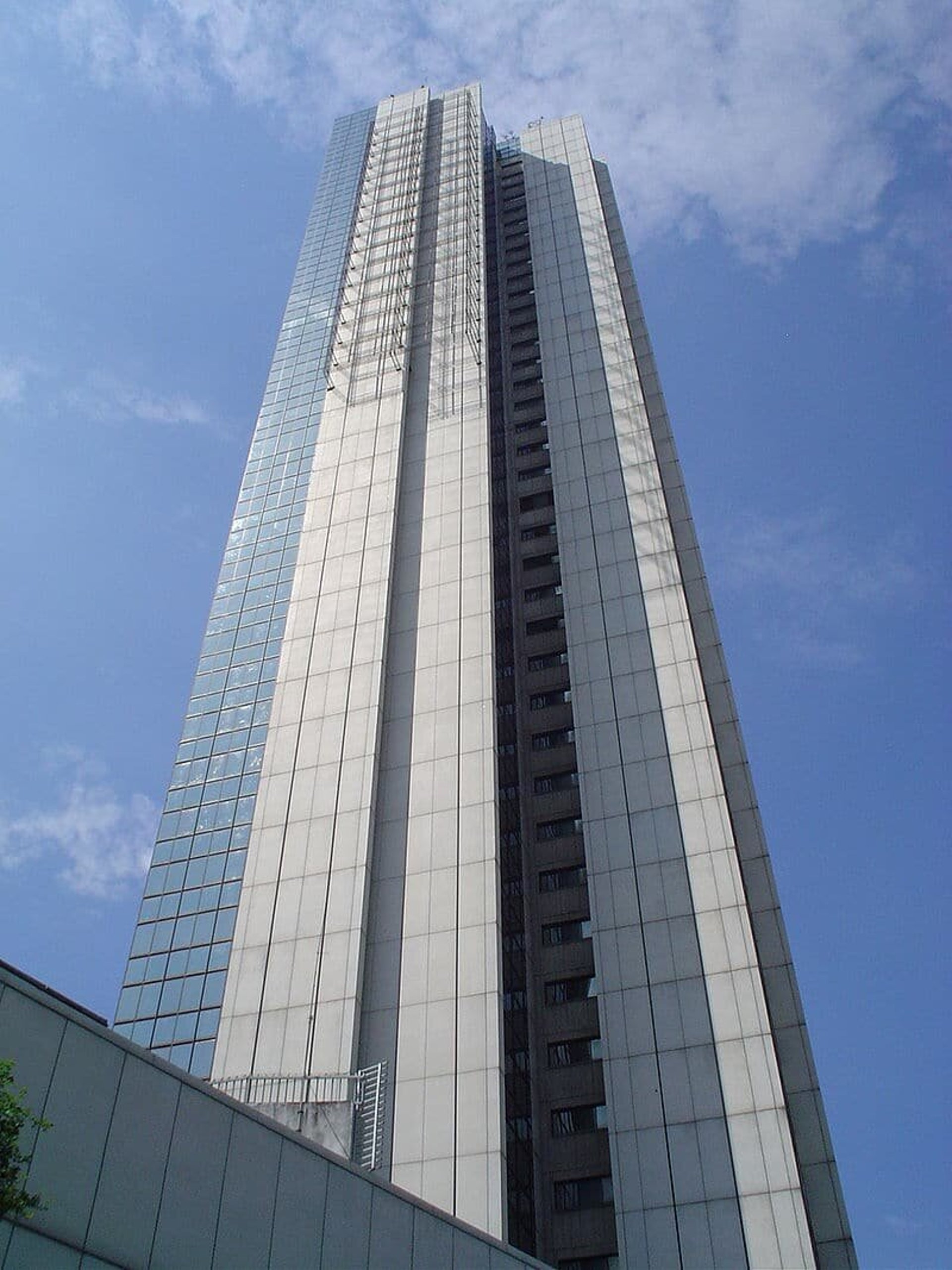 an abstract photo of a curved building with a blue sky in the background