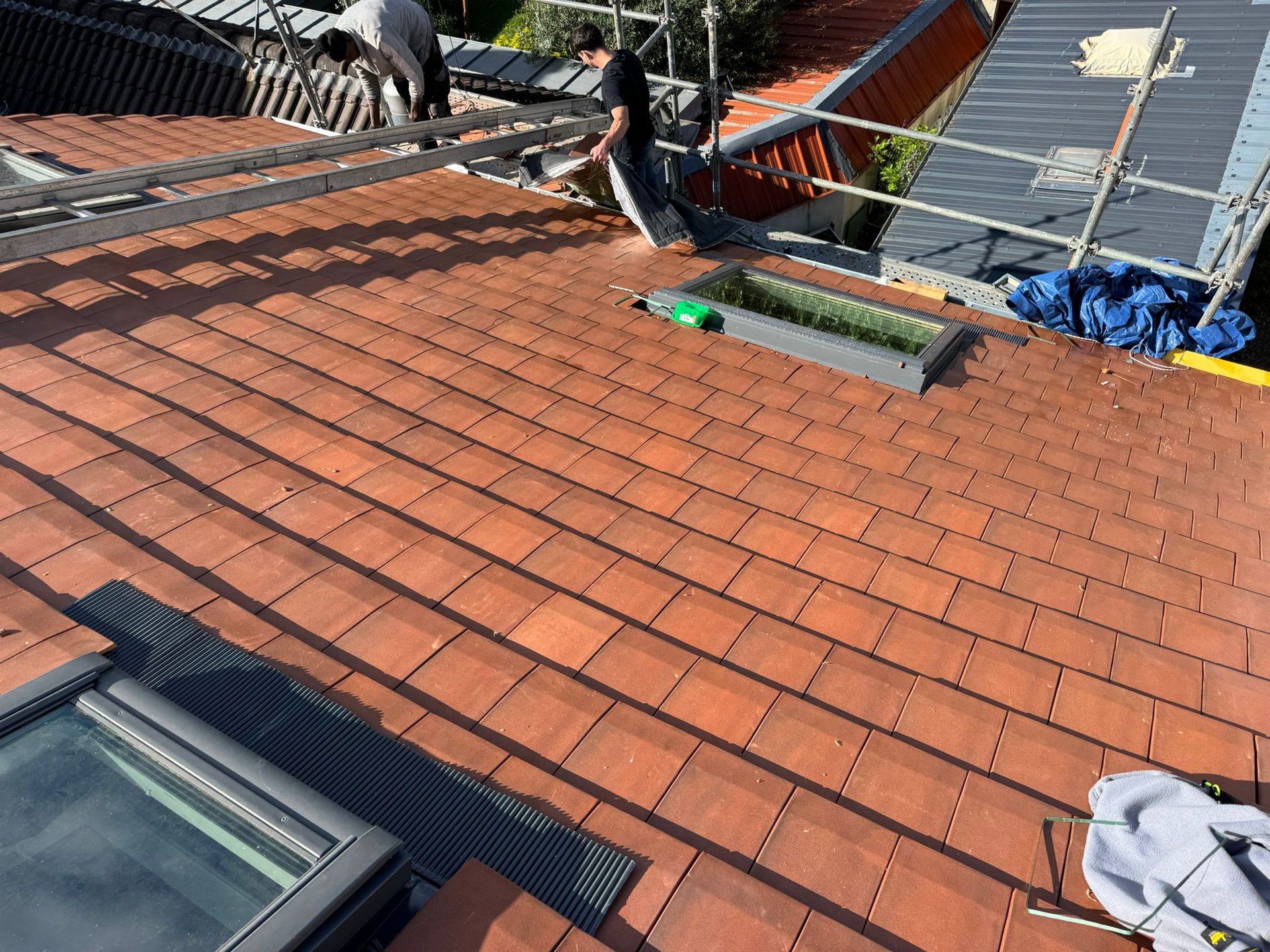 A roof with a birdhouse on top of it
