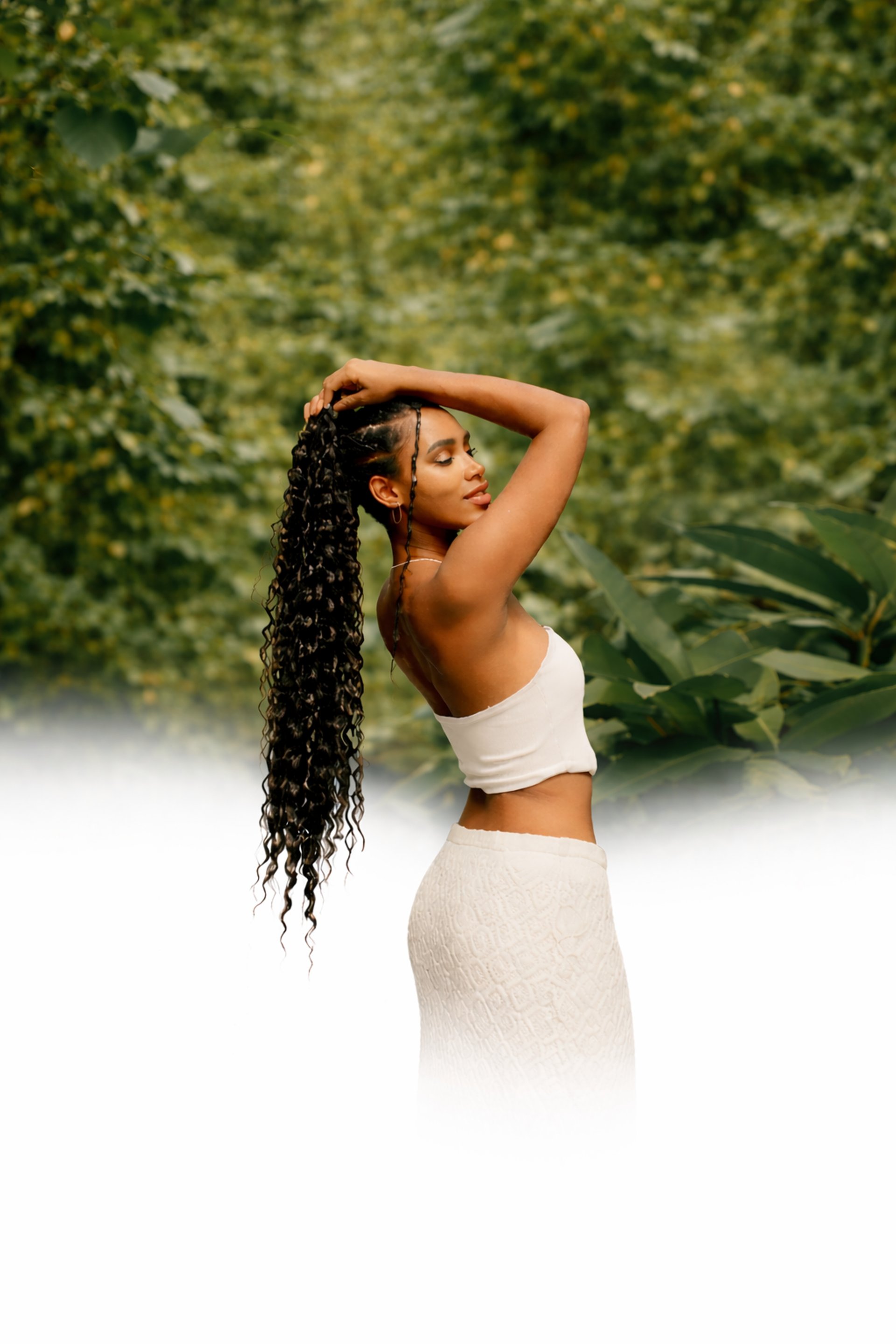 a woman with long hair standing in a greenhouse