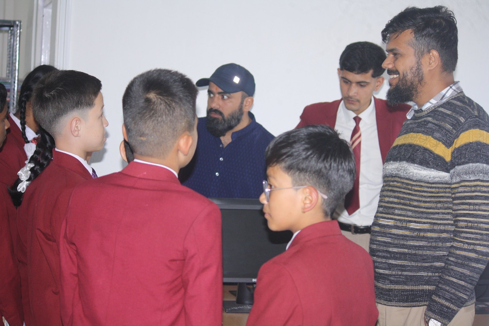 man in blue and white striped polo shirt standing beside woman in black shirt