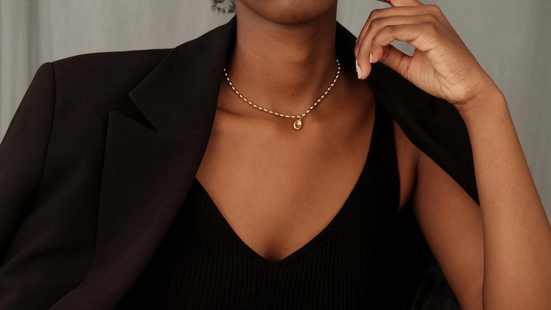 person wearing grey knit sweater