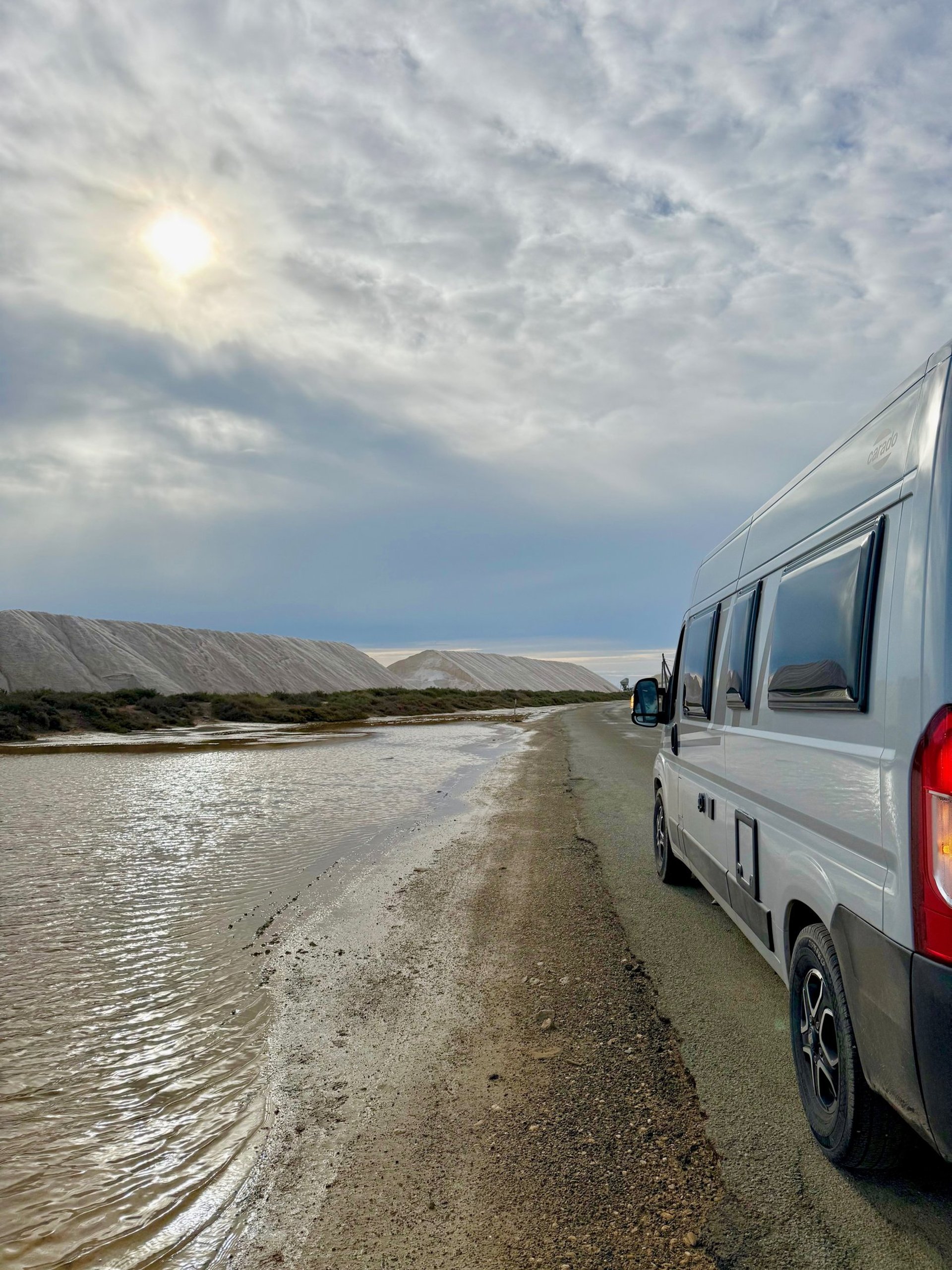 woman wearing yellow long-sleeved dress under white clouds and blue sky during daytime