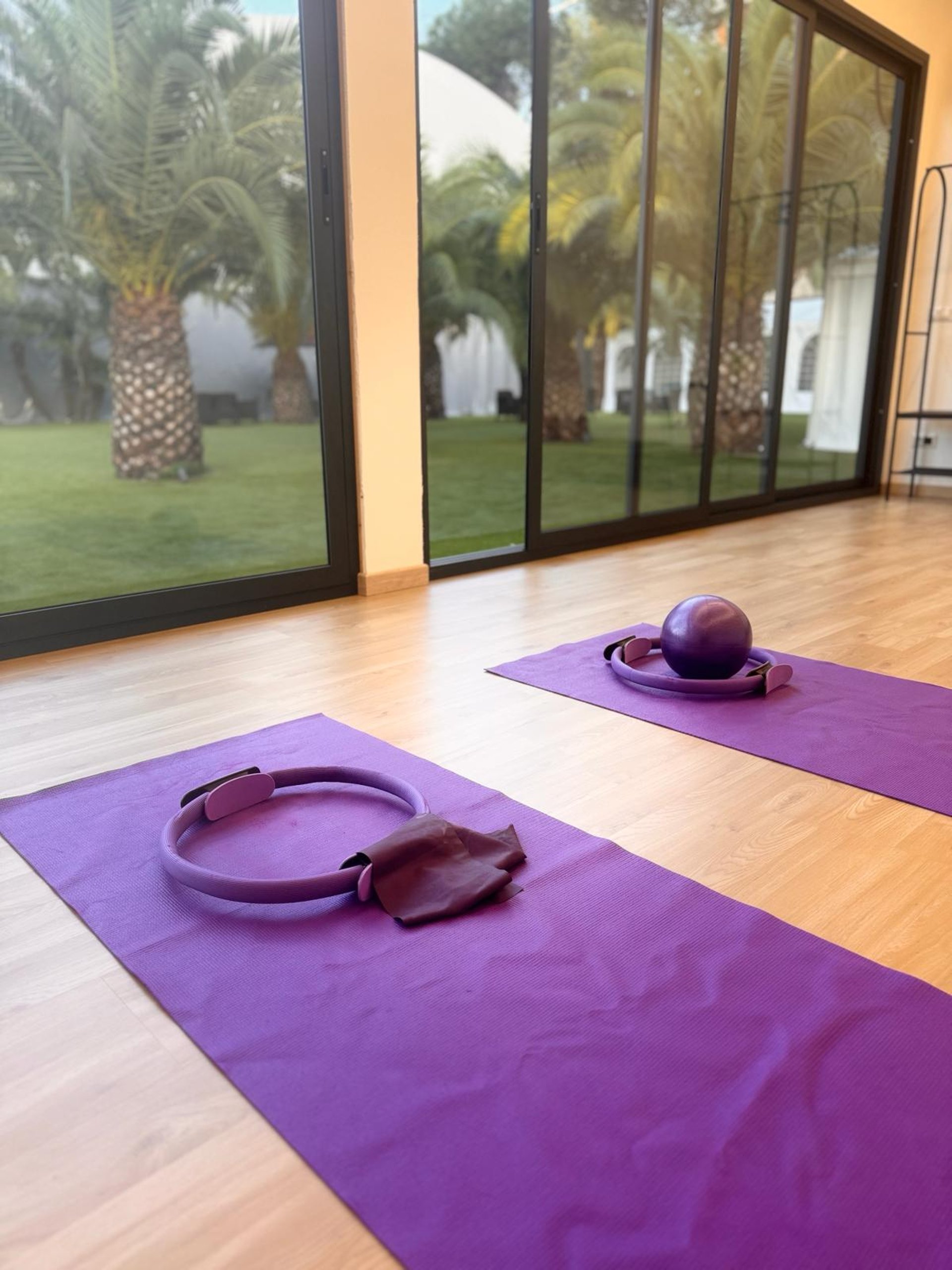 woman in black tank top and black leggings lying on black floor
