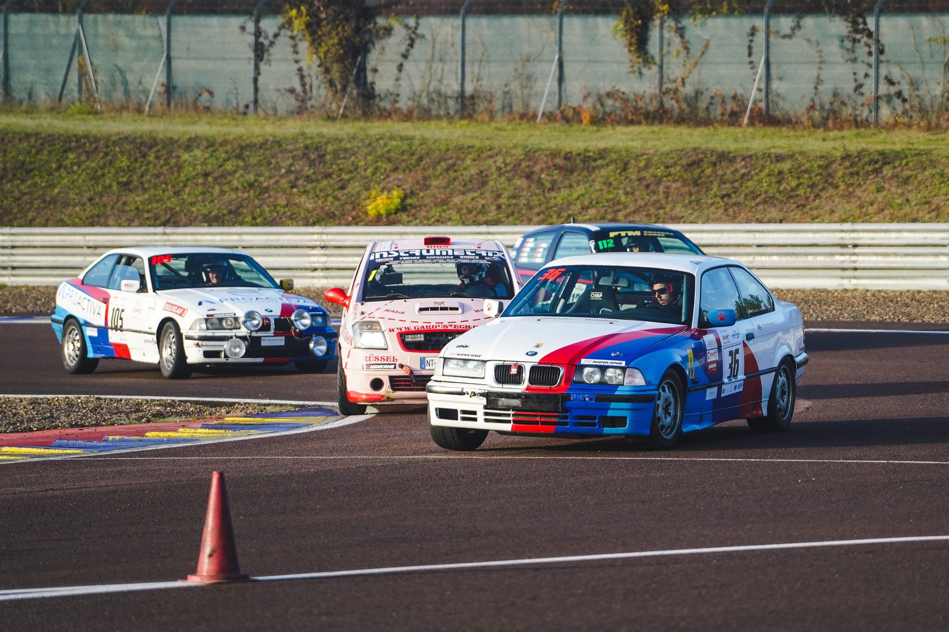 a yellow sports car driving on a race track