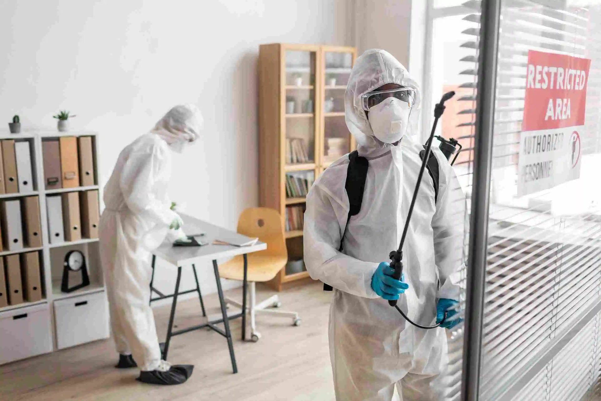 A group of people standing around a room