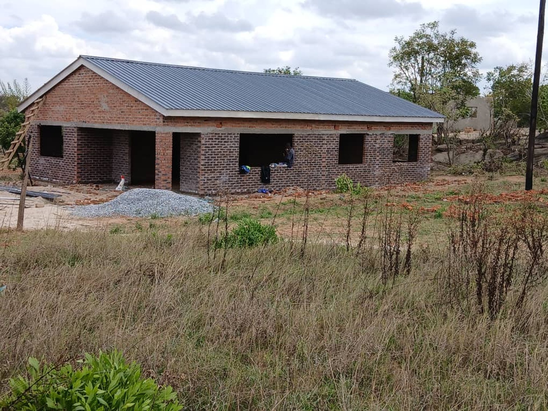 woman wearing yellow long-sleeved dress under white clouds and blue sky during daytime