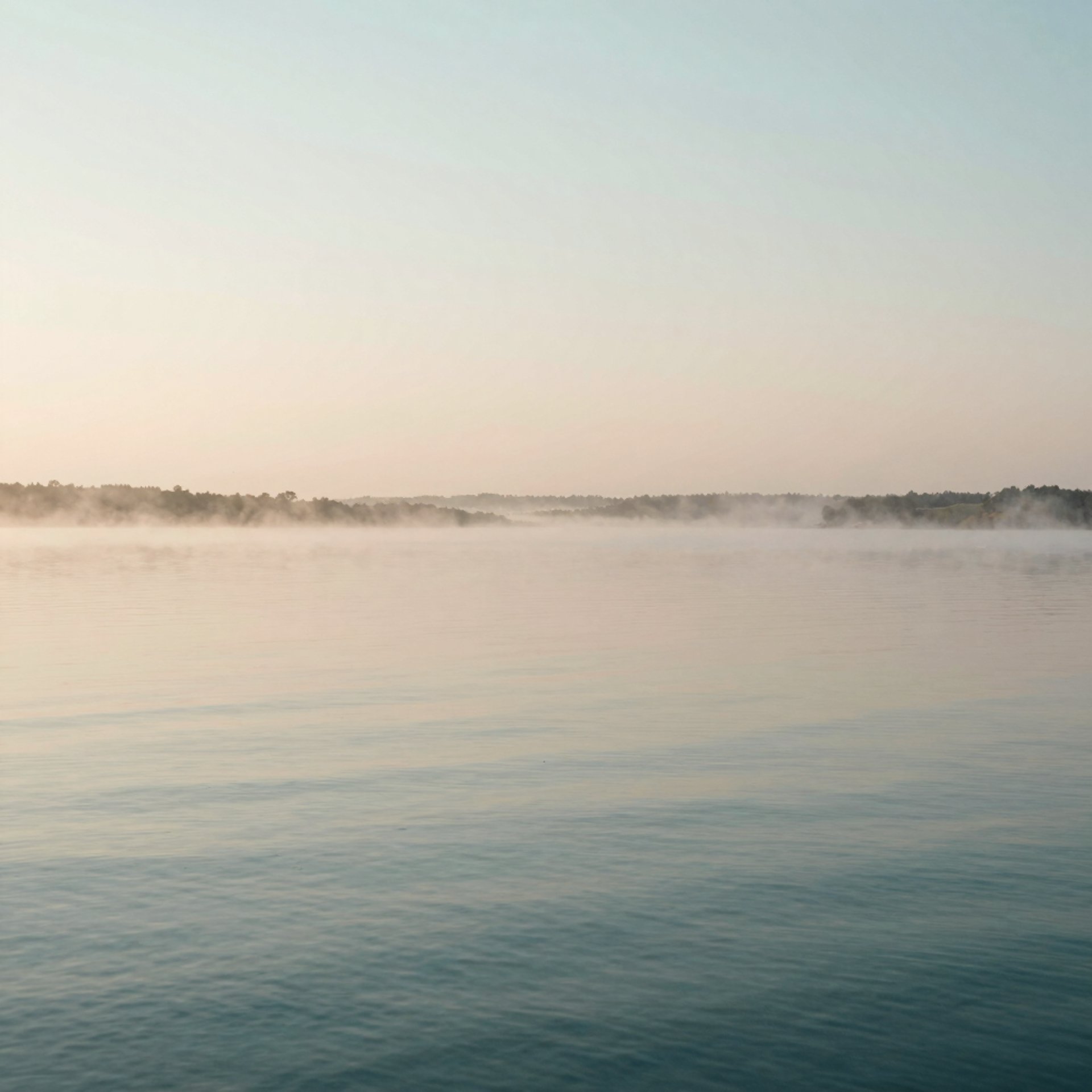 a body of water with mountains in the background