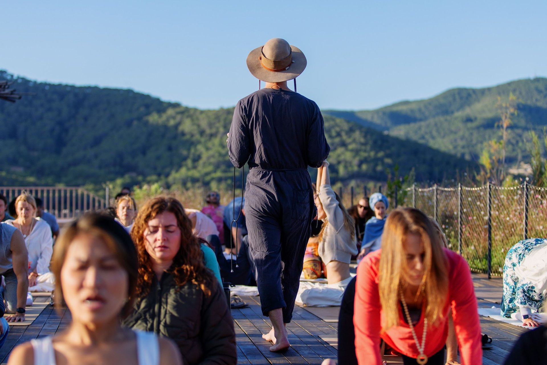 silhouette of person standing on rock surrounded by body of water