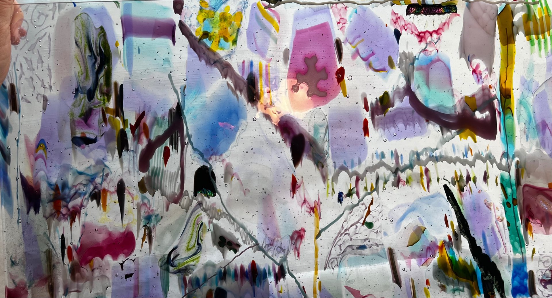 Abstract fused glass with pinks and purples fire at slant