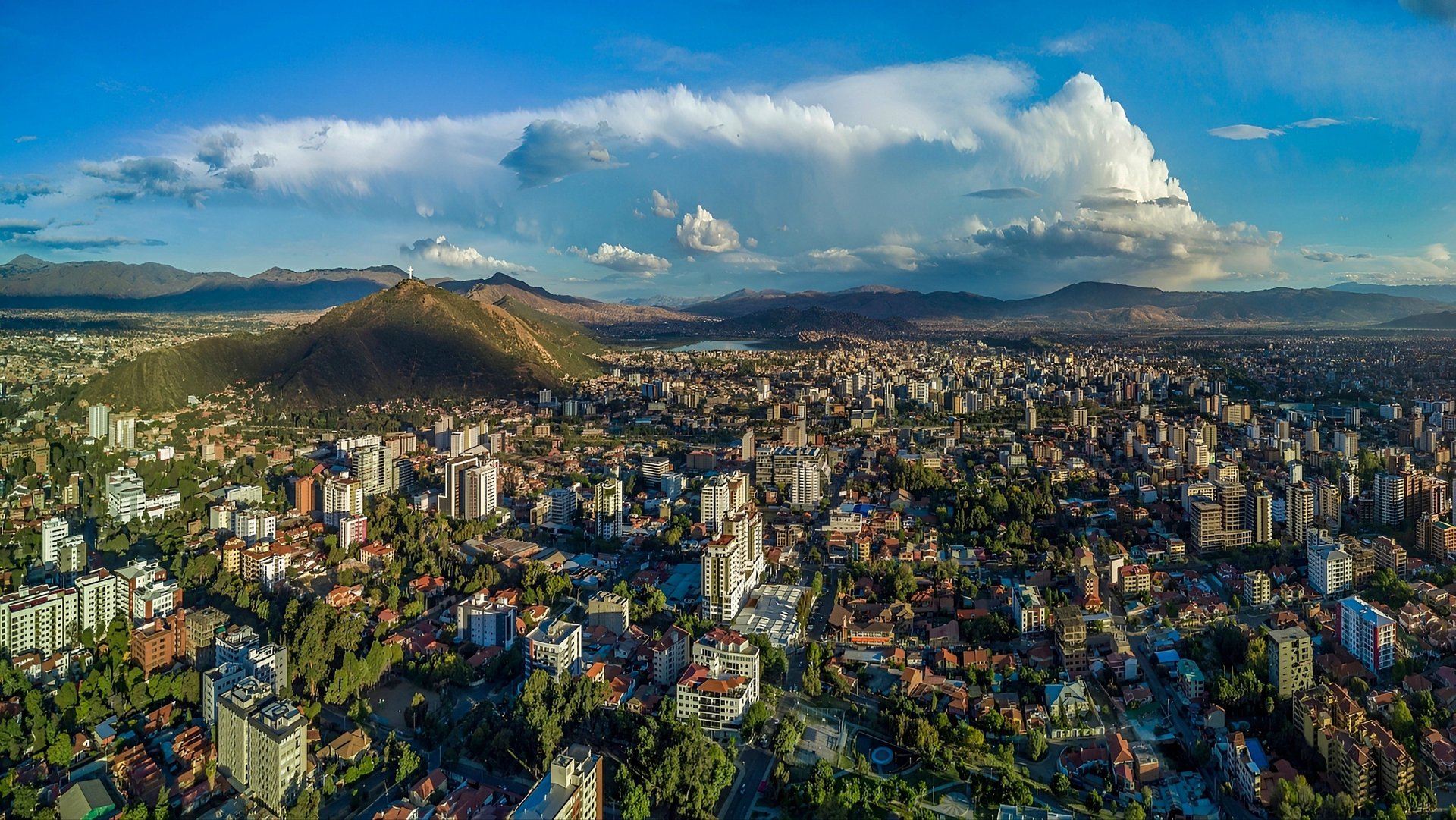 woman wearing yellow long-sleeved dress under white clouds and blue sky during daytime