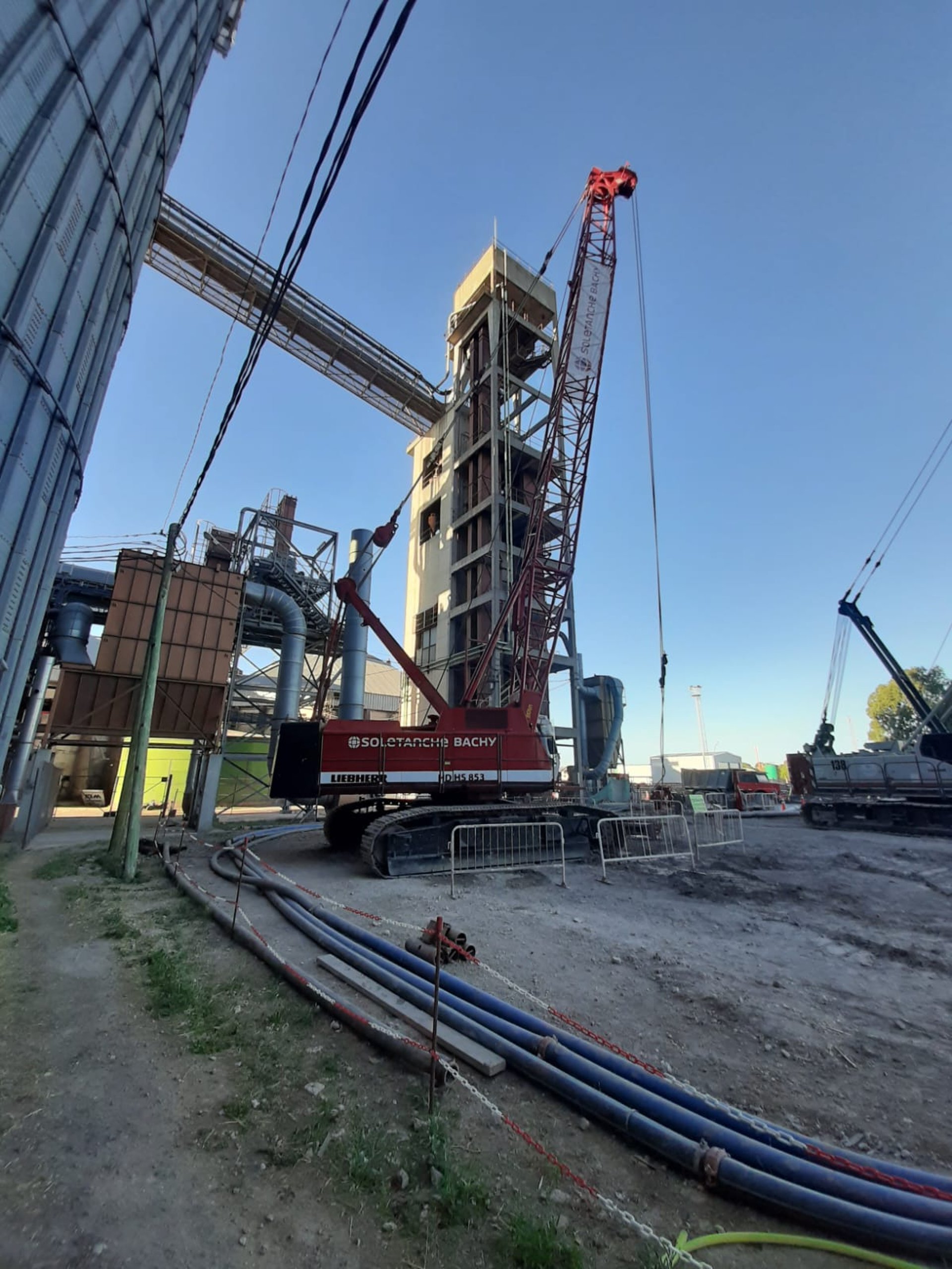 an abstract photo of a curved building with a blue sky in the background