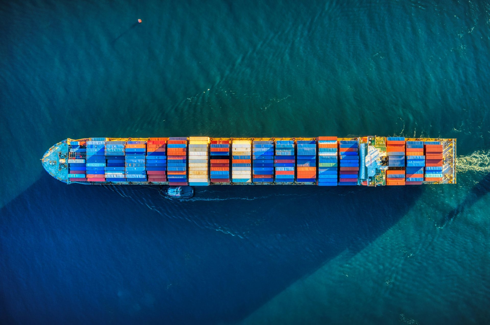 aerial view of blue and white boat on body of water during daytime