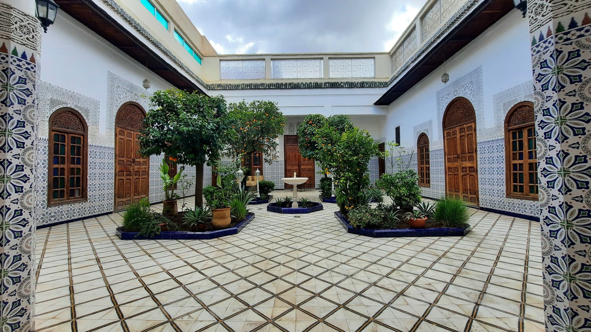 woman wearing yellow long-sleeved dress under white clouds and blue sky during daytime