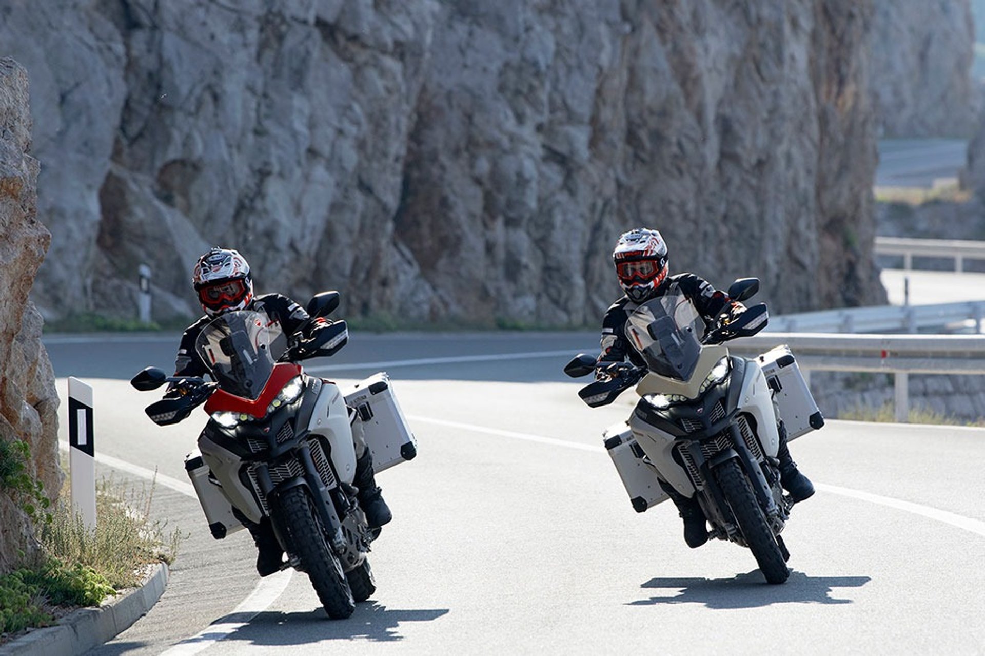 black and white photo of people riding motorcycle