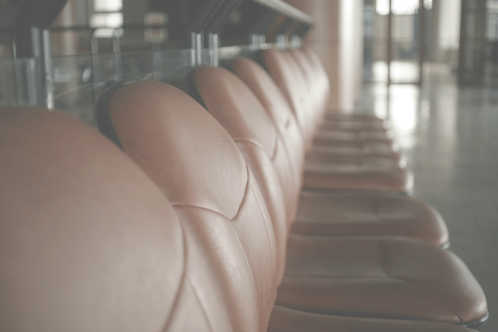 person walking on street while holding black umbrella near cars on road at nighttime