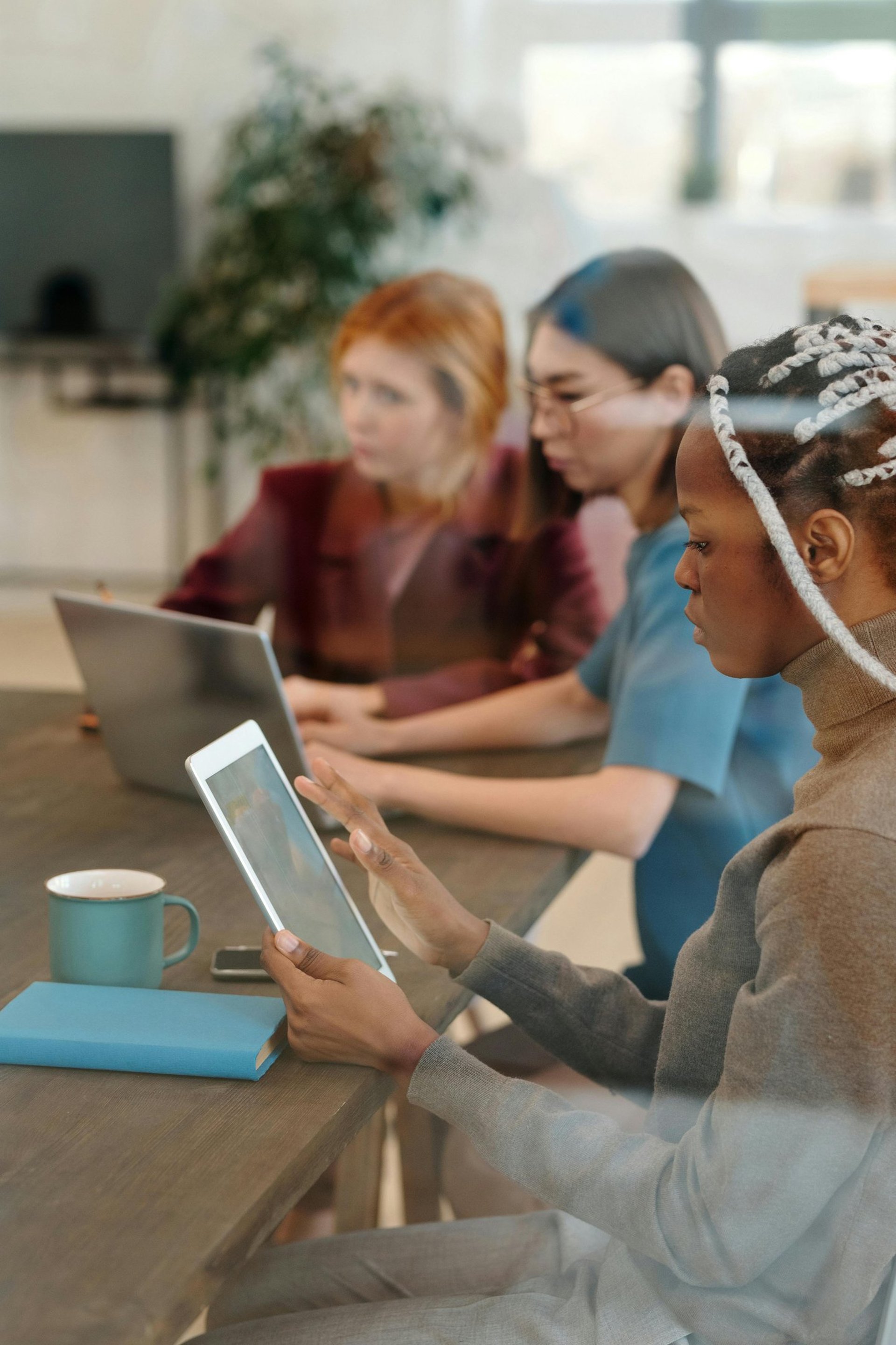3 women sitting on chair