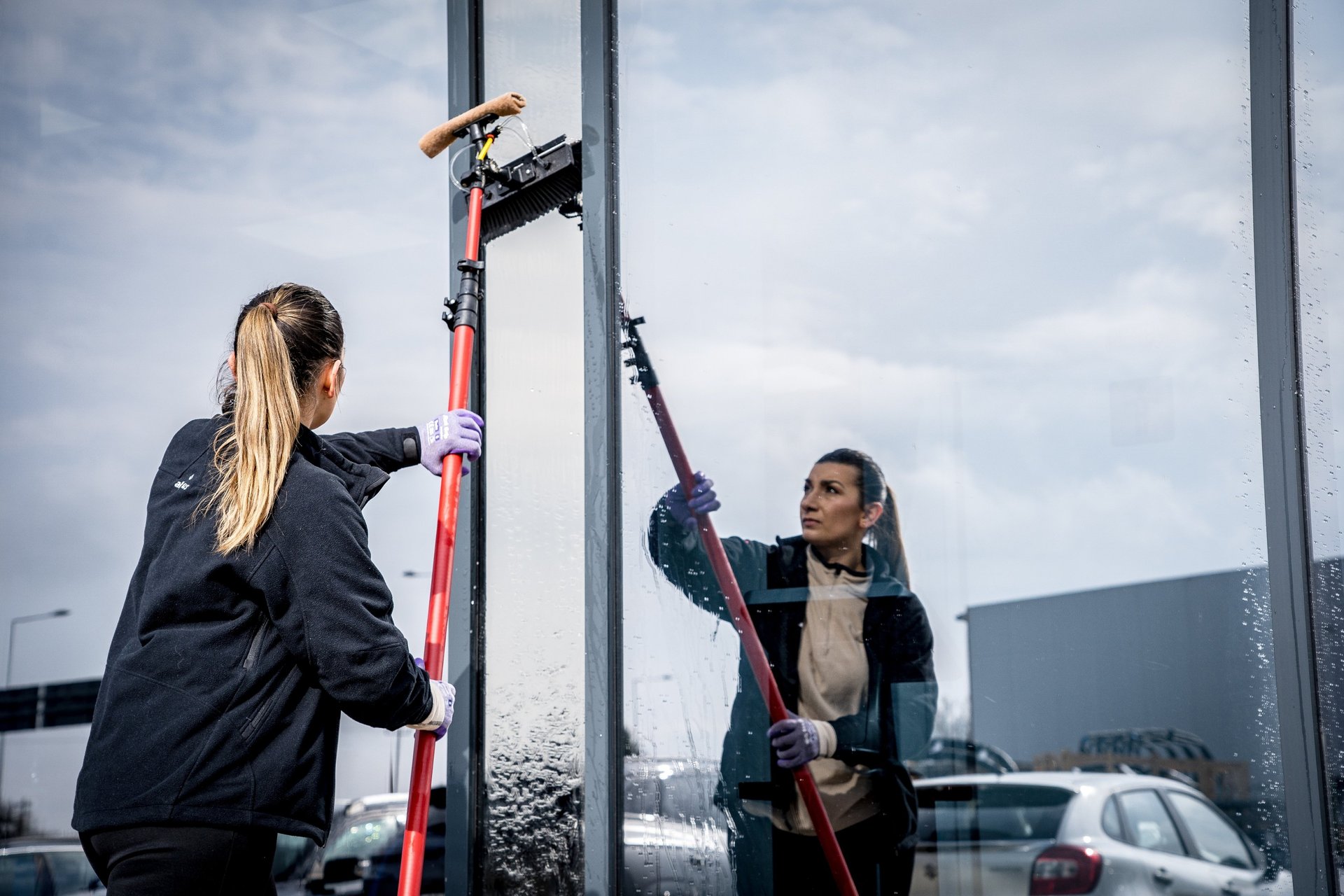 man wearing black jacket holding rod