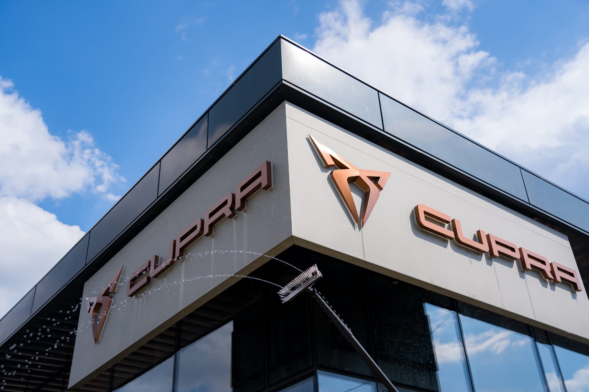 A man sanding a wooden table with a sander
