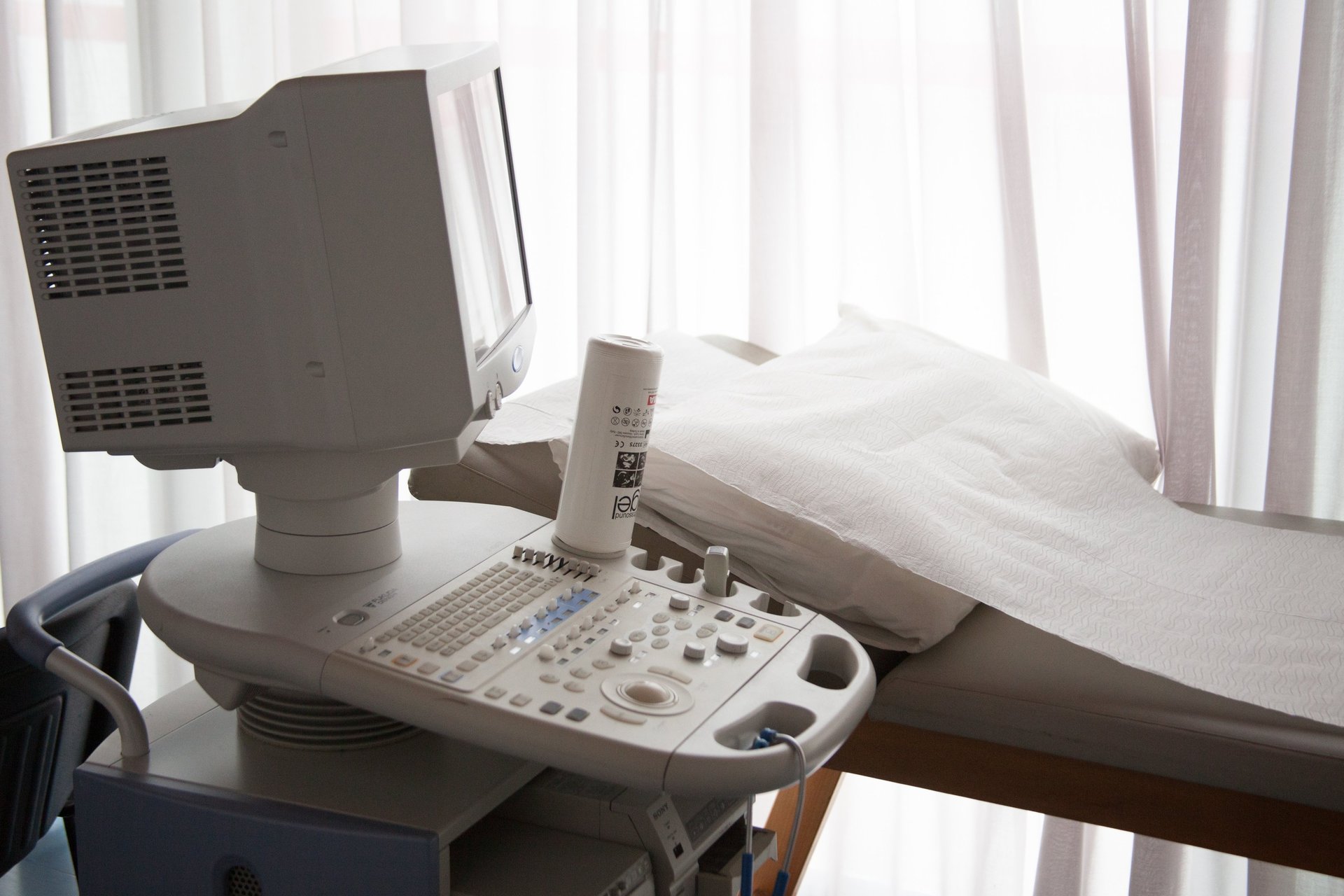 a person in blue gloves is operating a machine