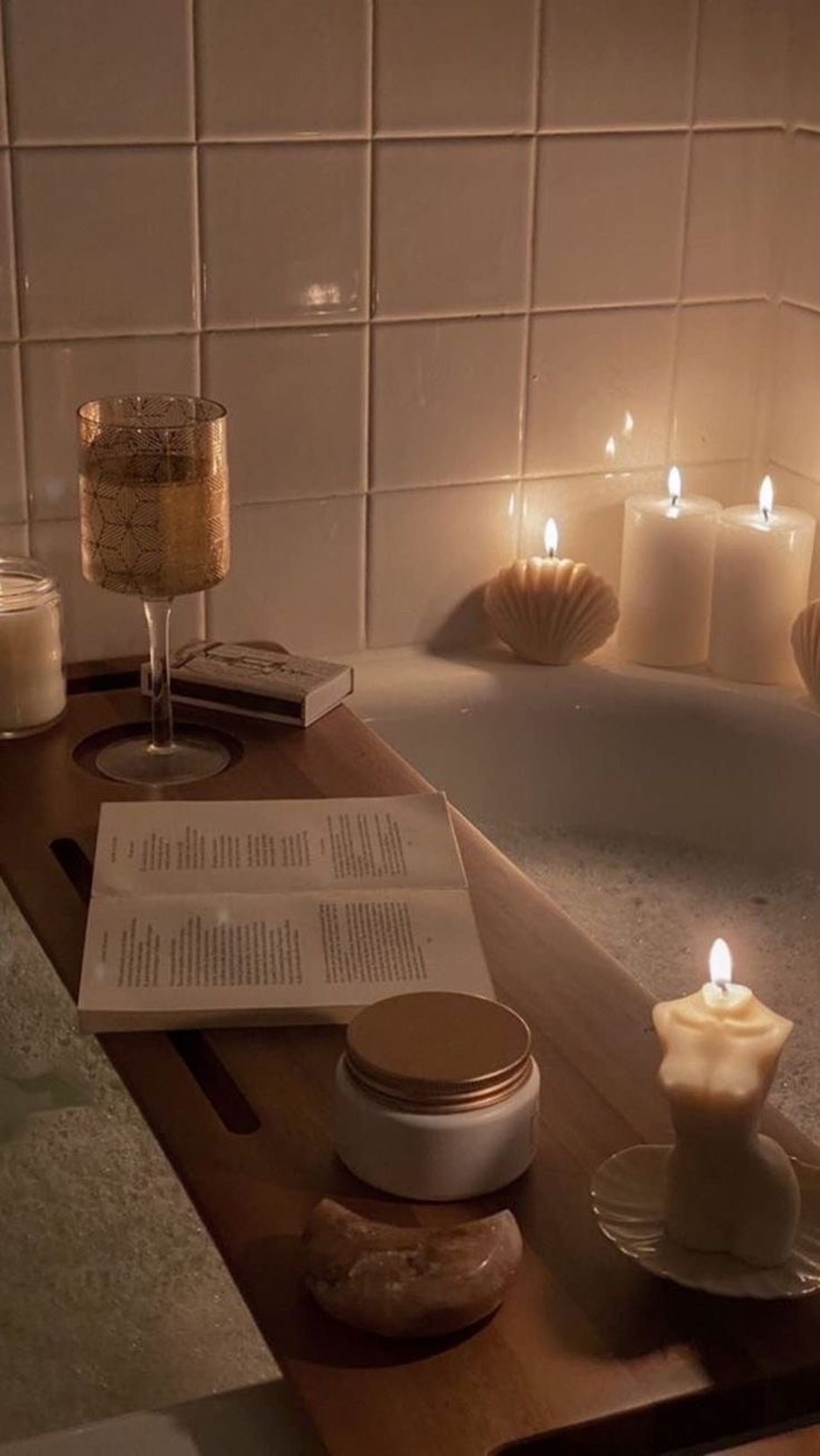 a cup of coffee and some books on a bathtub