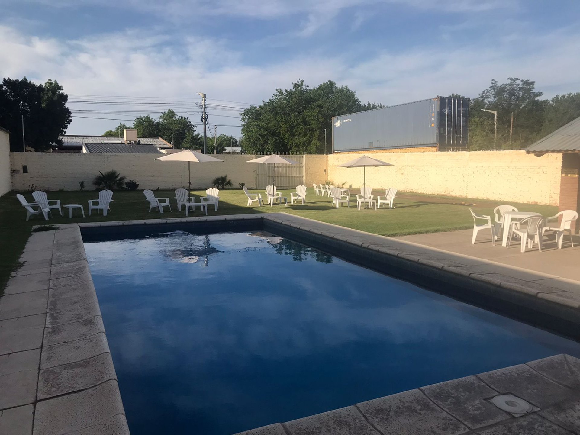woman wearing yellow long-sleeved dress under white clouds and blue sky during daytime