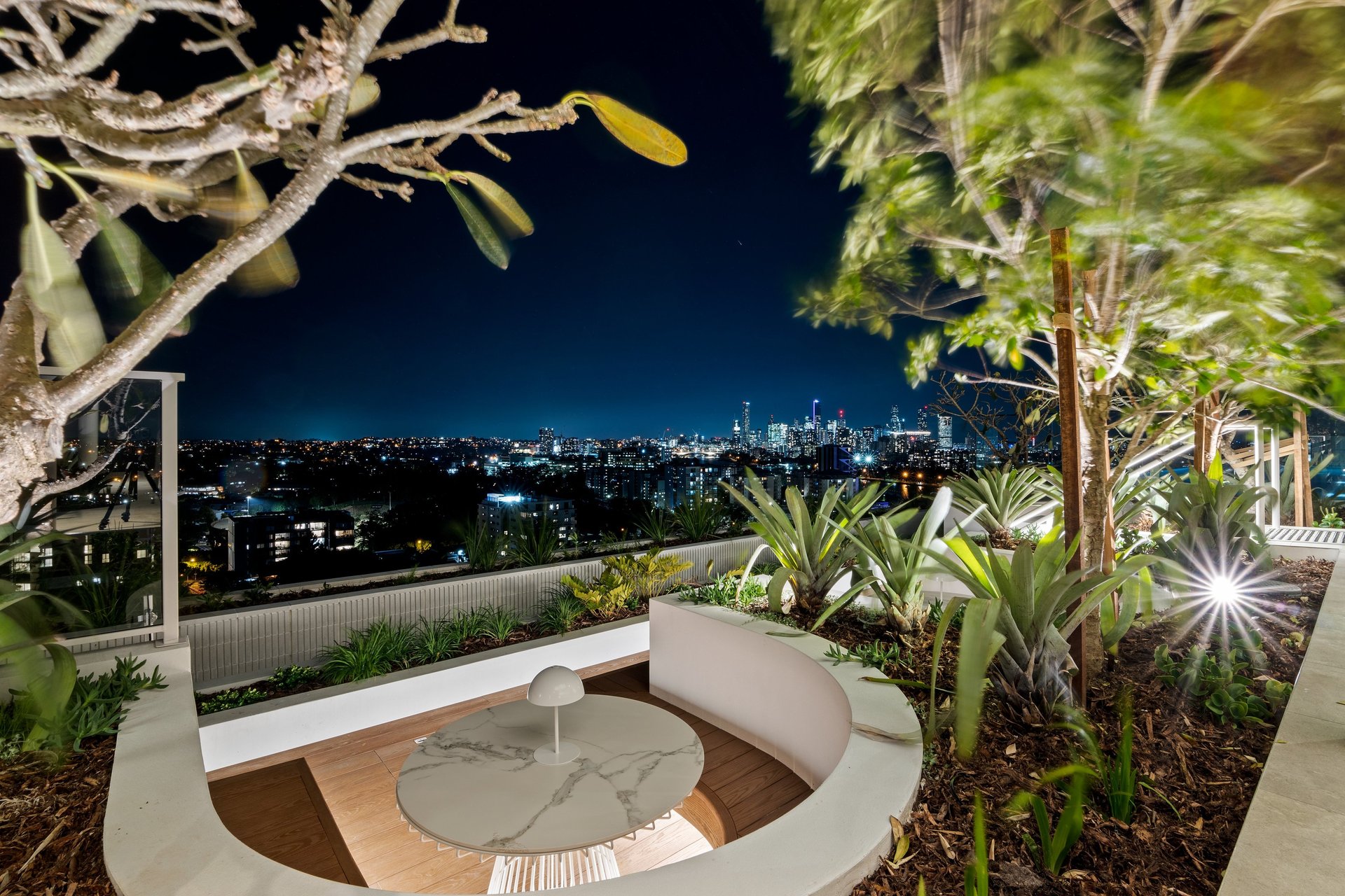 a group of tall buildings under a cloudy blue sky