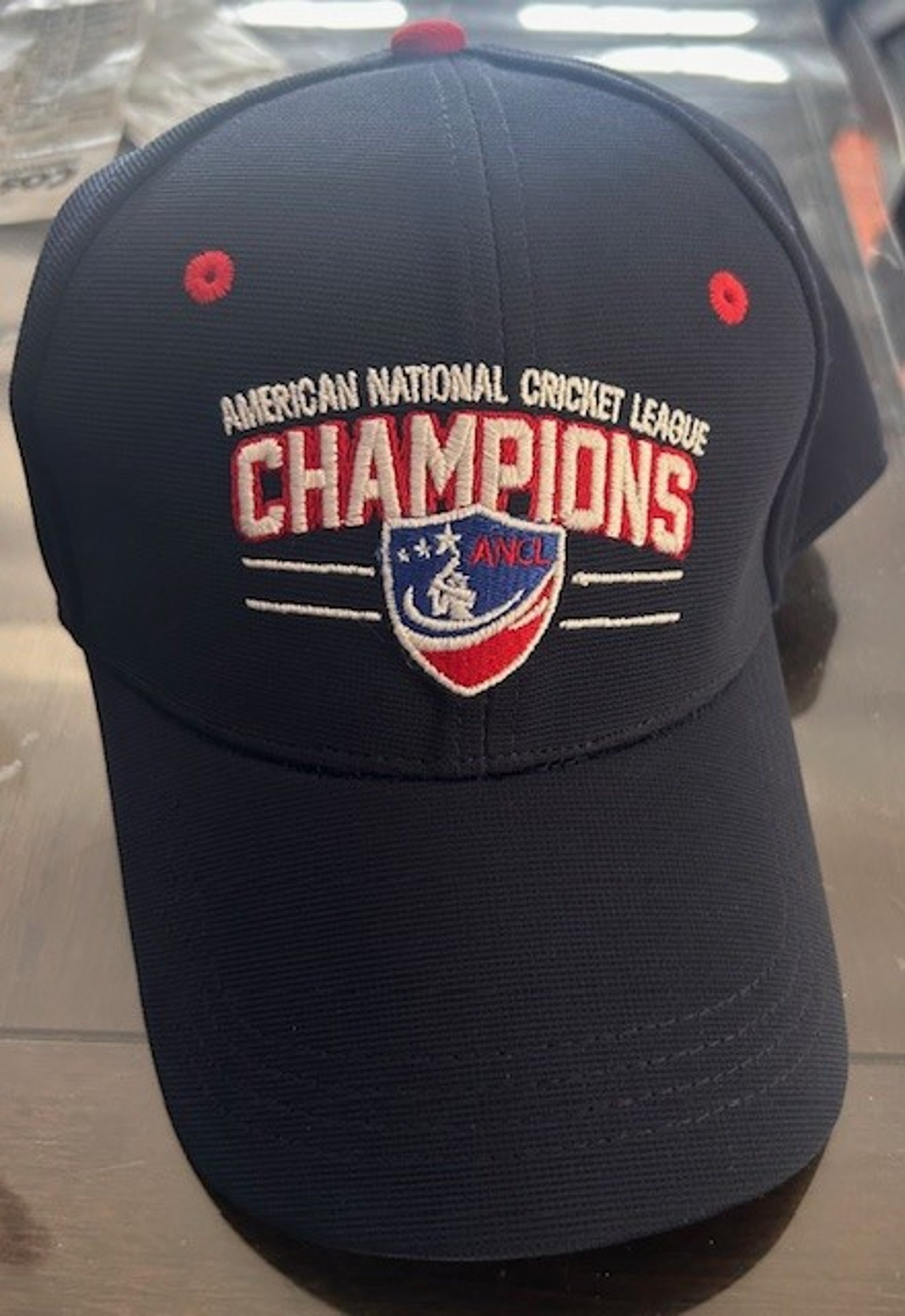 green grass field near mountain under blue sky during daytime