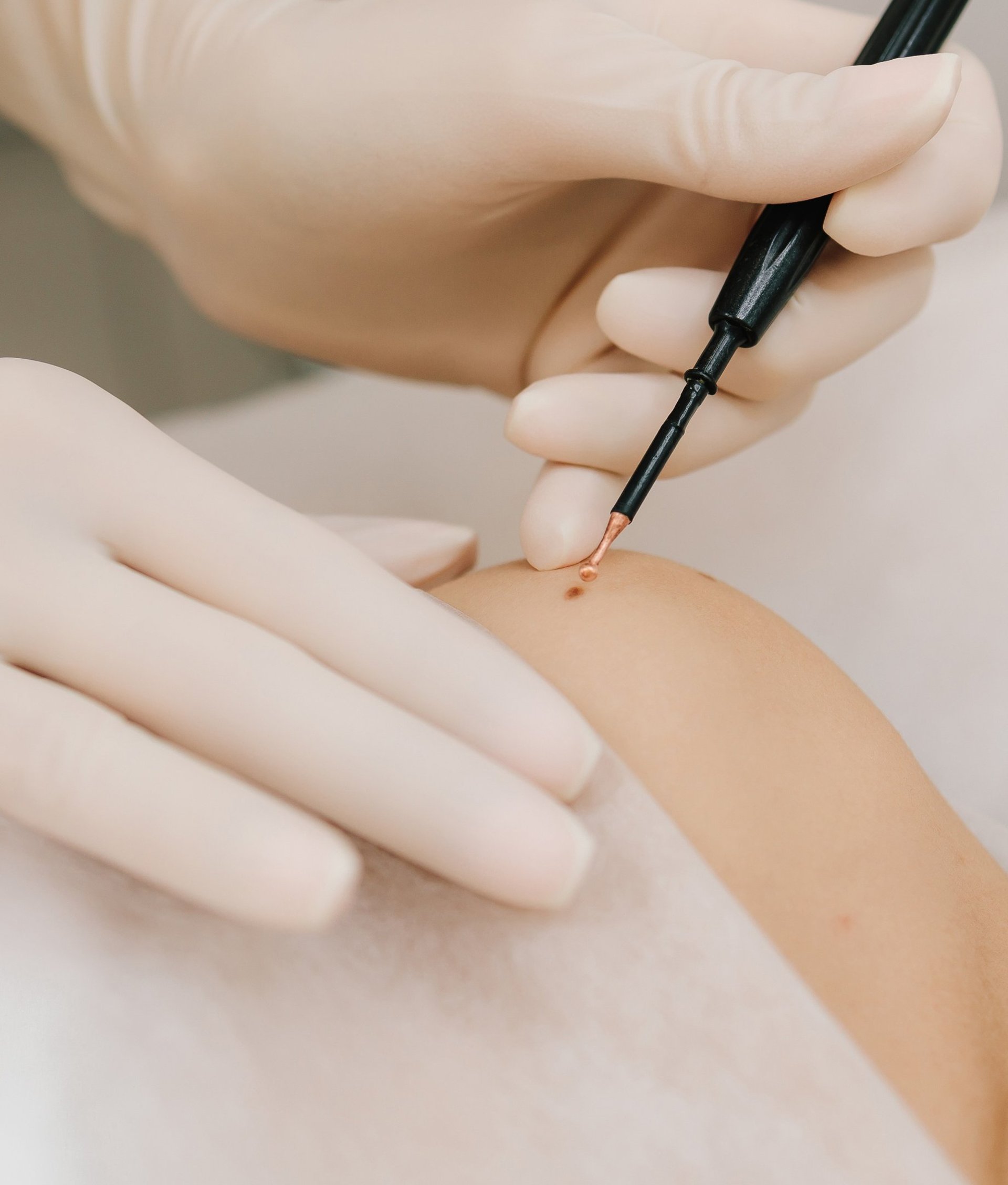 A woman in a hospital gown is getting an injection