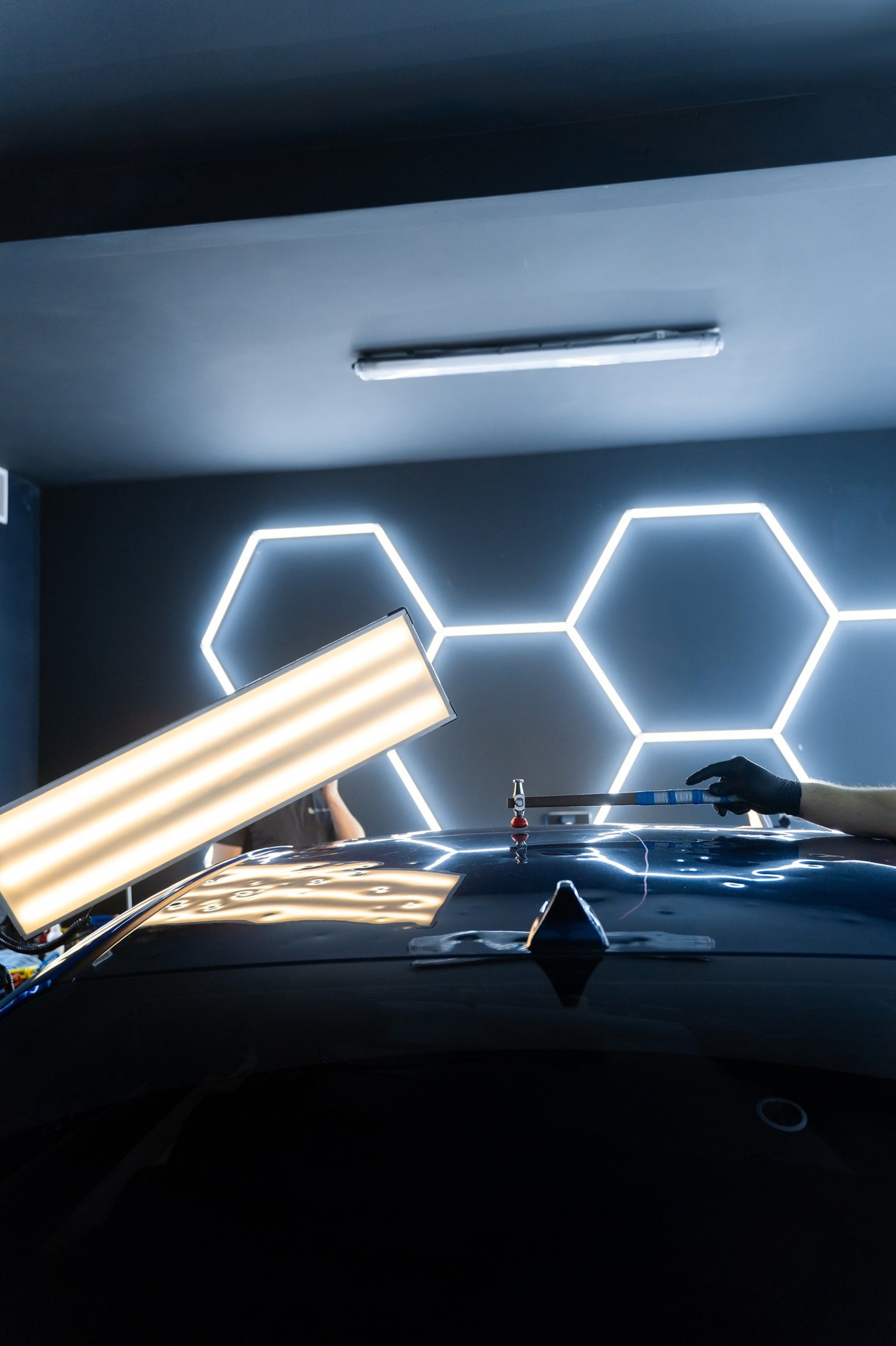 black car in the dark with lighted daytime running lights