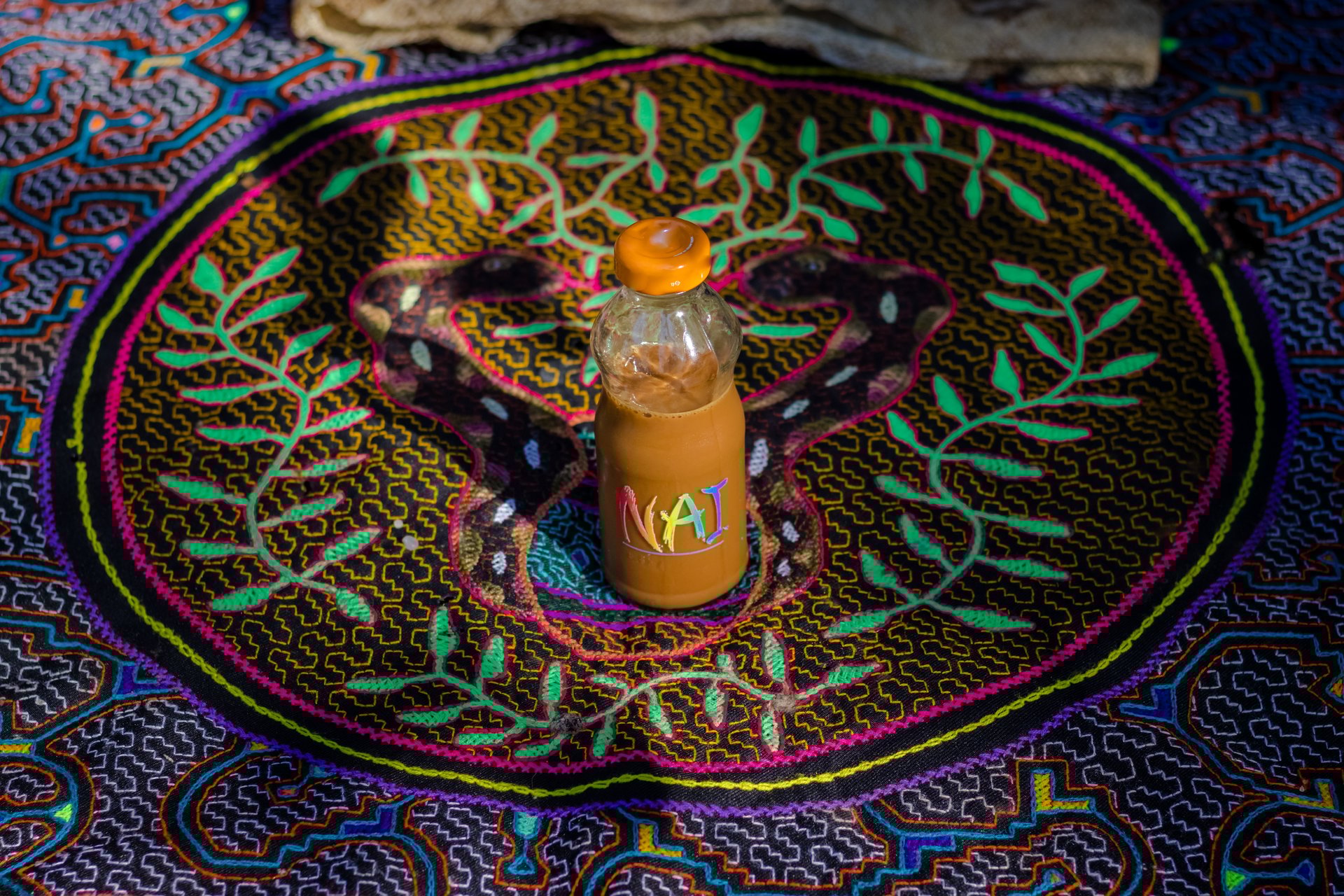 green grass field under white clouds and rainbow