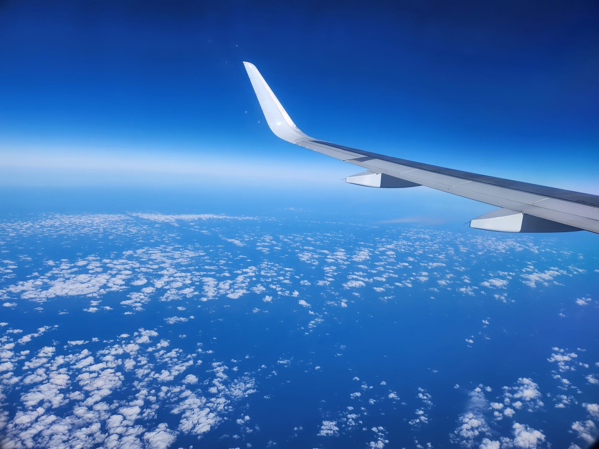 airplane window view of white clouds during daytime