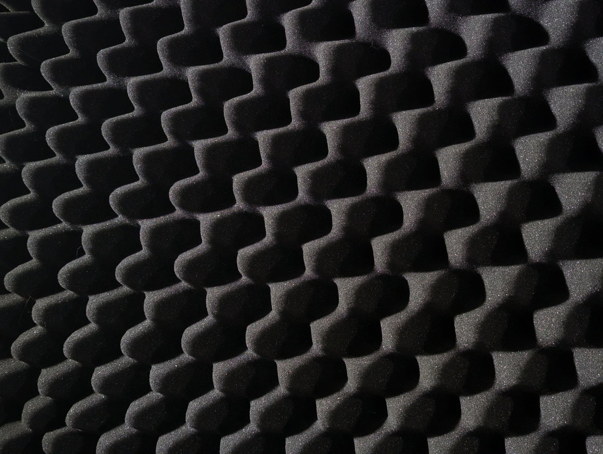 an abstract photo of a curved building with a blue sky in the background