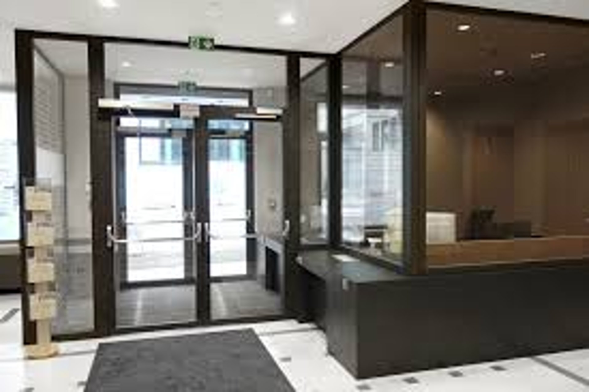 an abstract photo of a curved building with a blue sky in the background