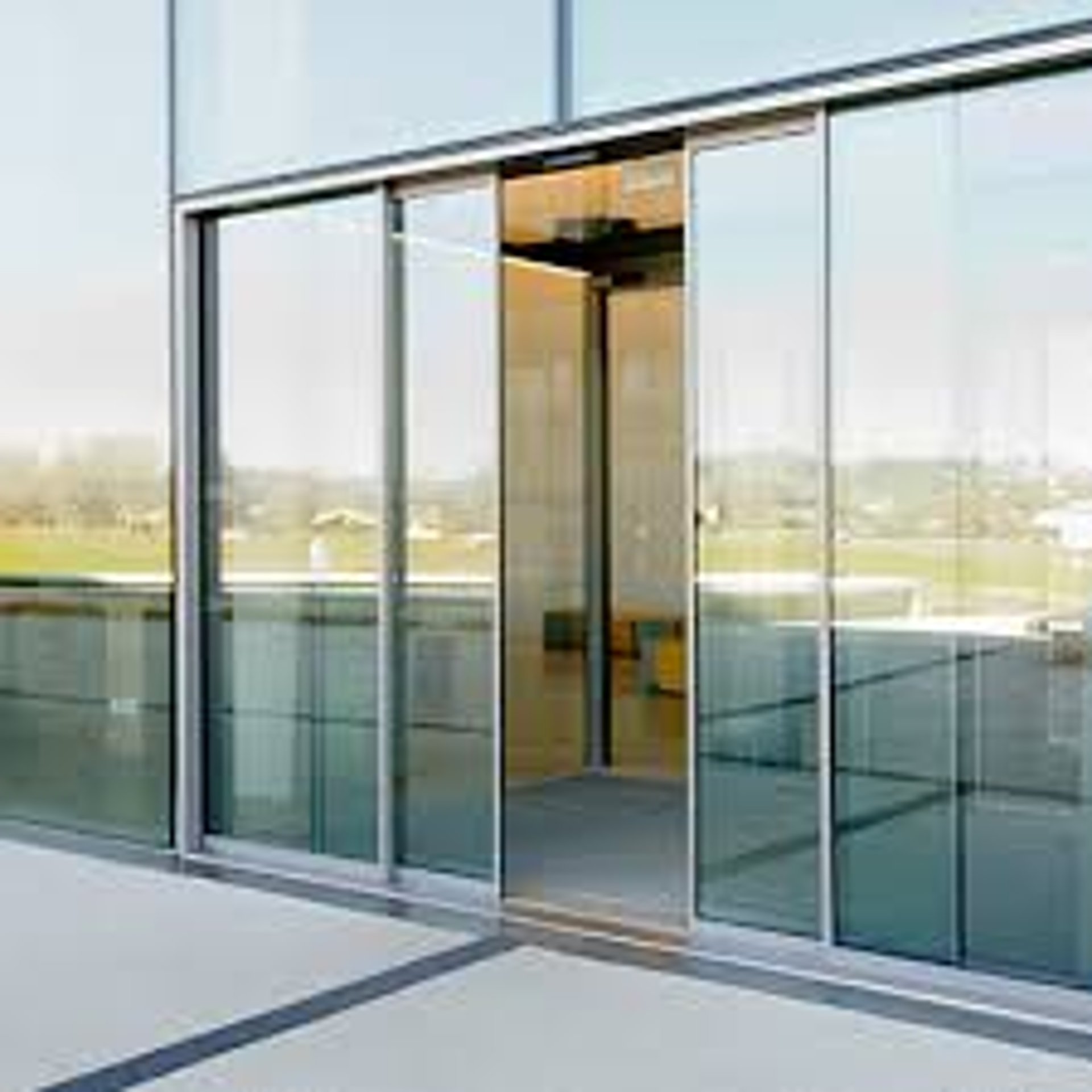 an abstract photo of a curved building with a blue sky in the background