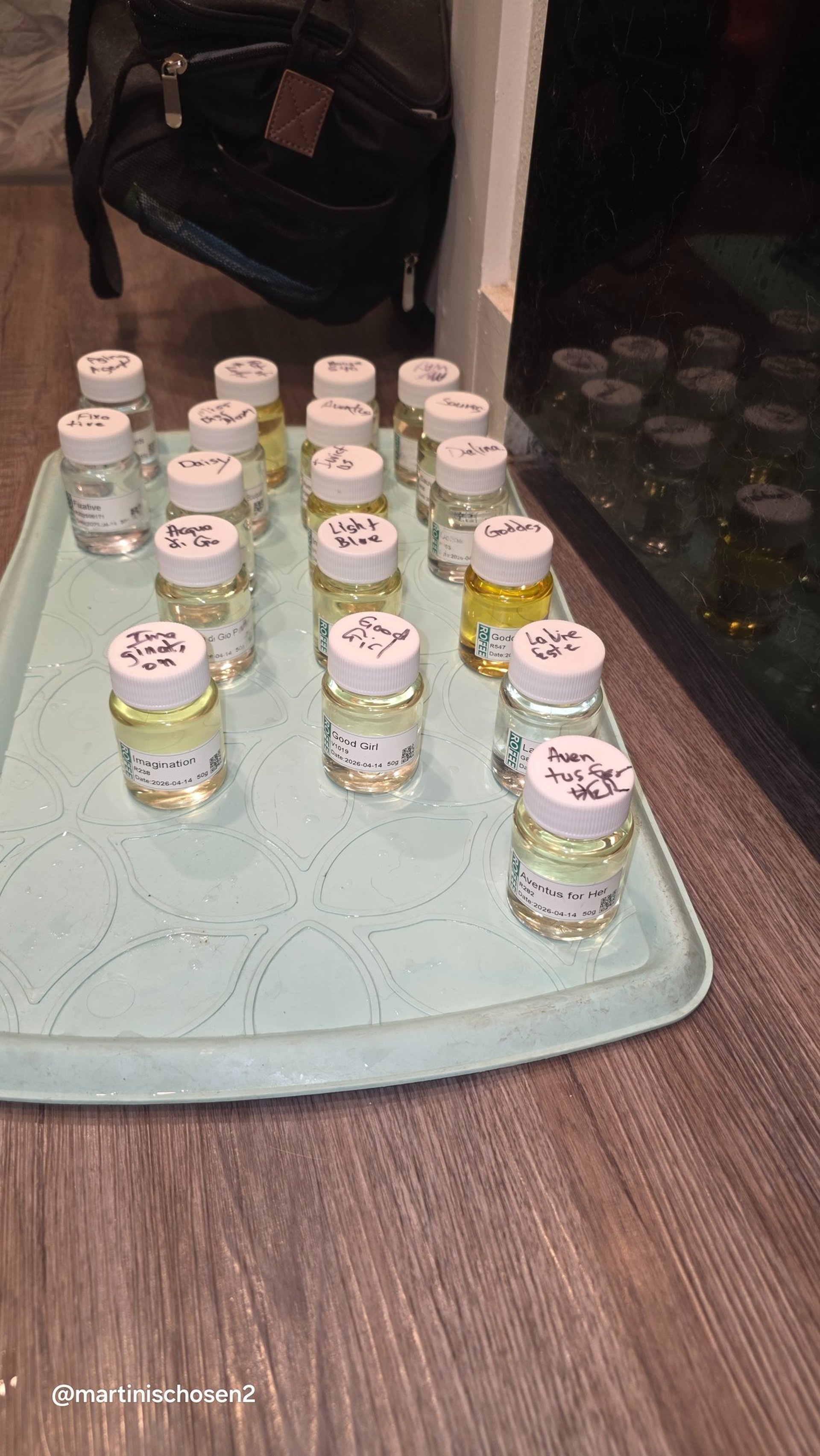 Close-up of professional-grade concentrated perfume oils featuring designer-inspired scent profiles.