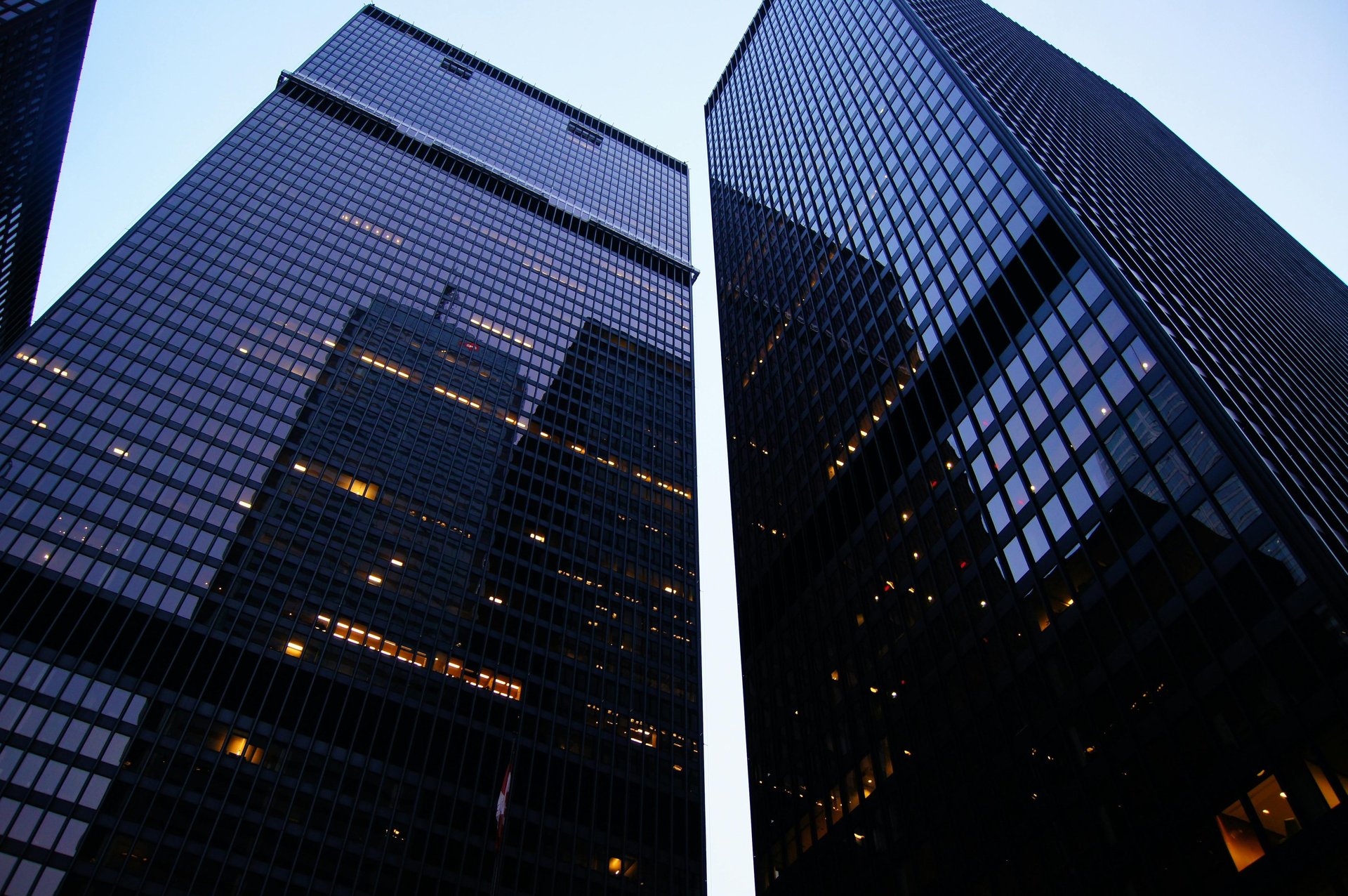 an abstract photo of a curved building with a blue sky in the background