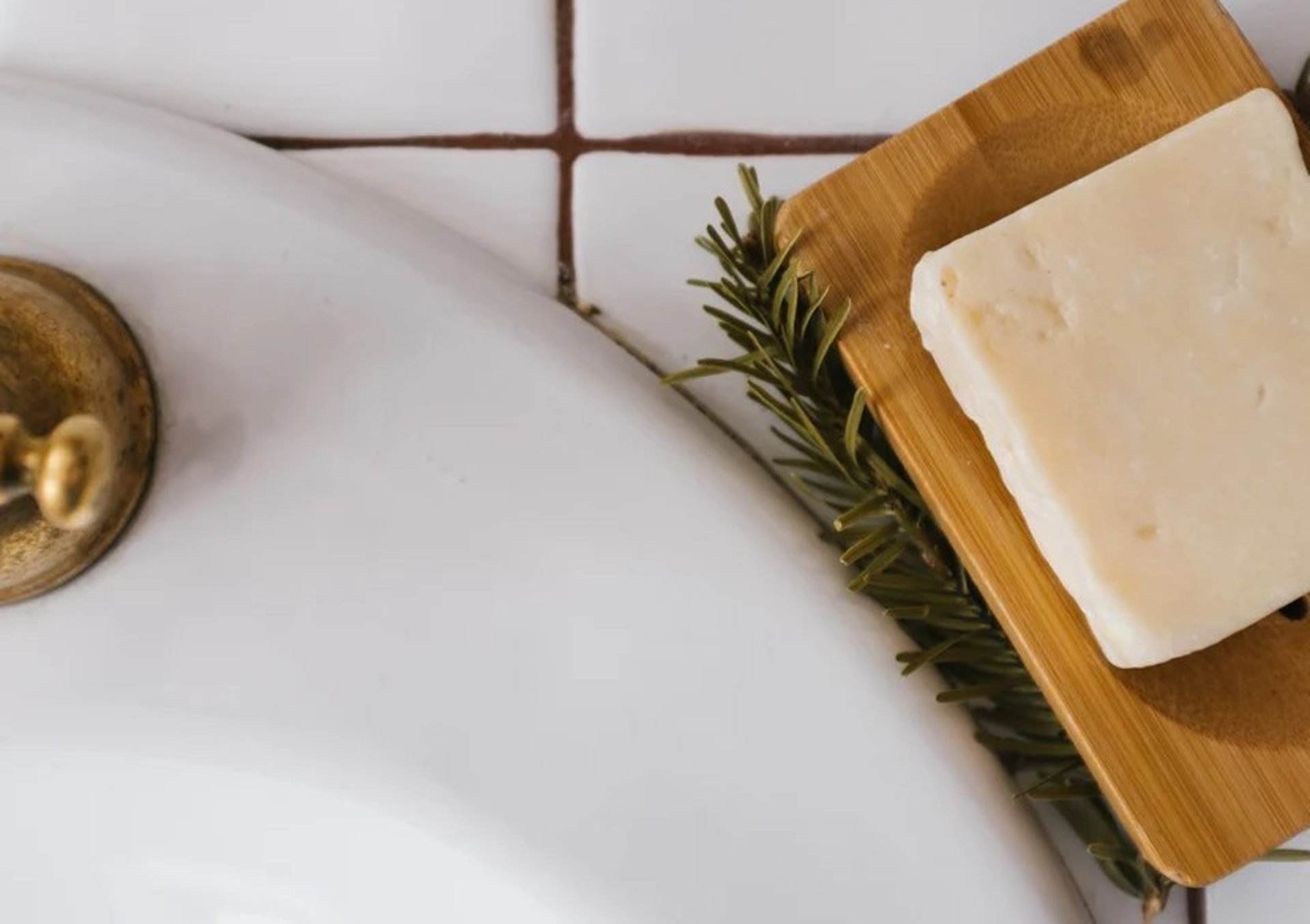 gold round ornament on white ceramic sink