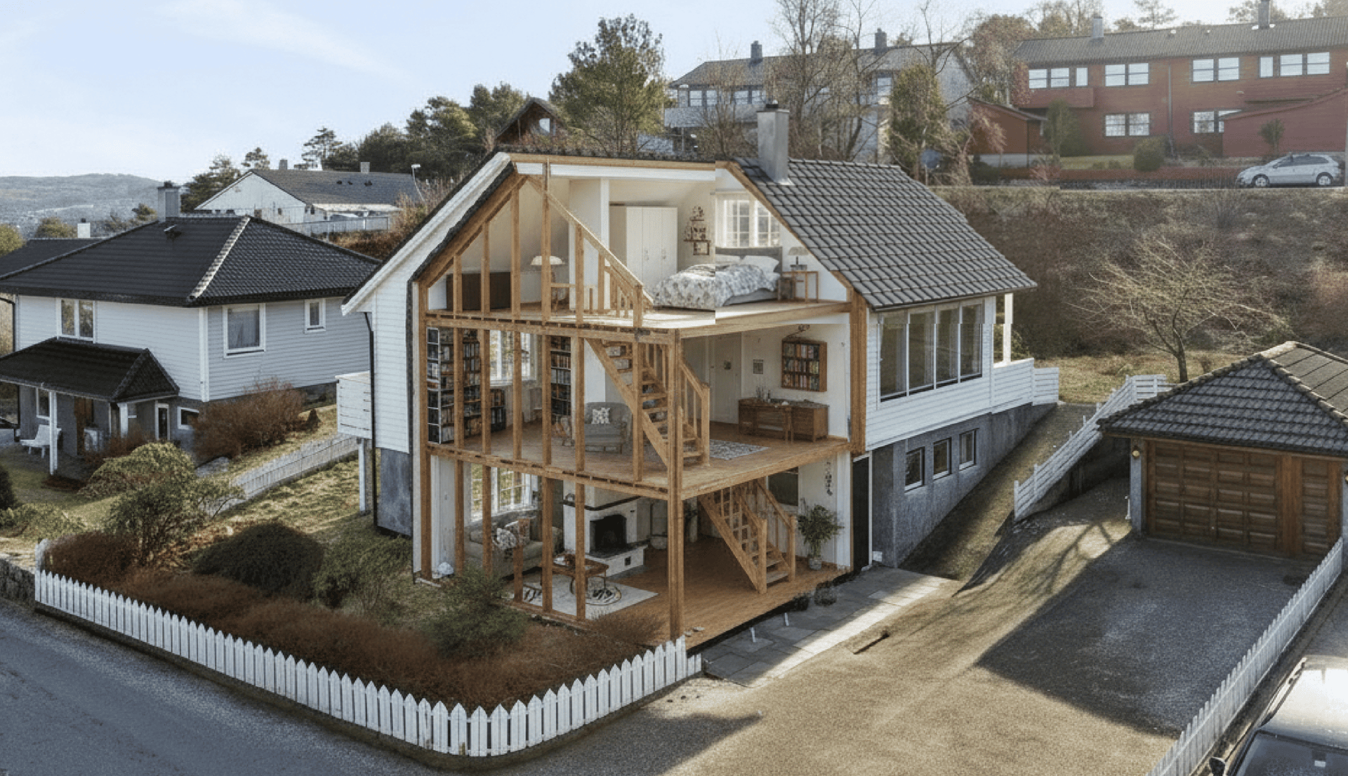 a tree with no leaves in front of a house