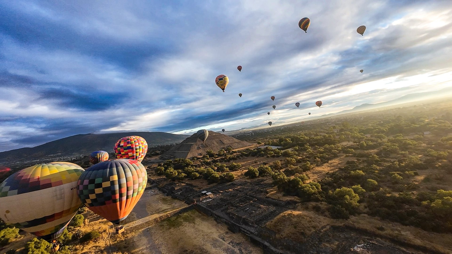 woman wearing yellow long-sleeved dress under white clouds and blue sky during daytime