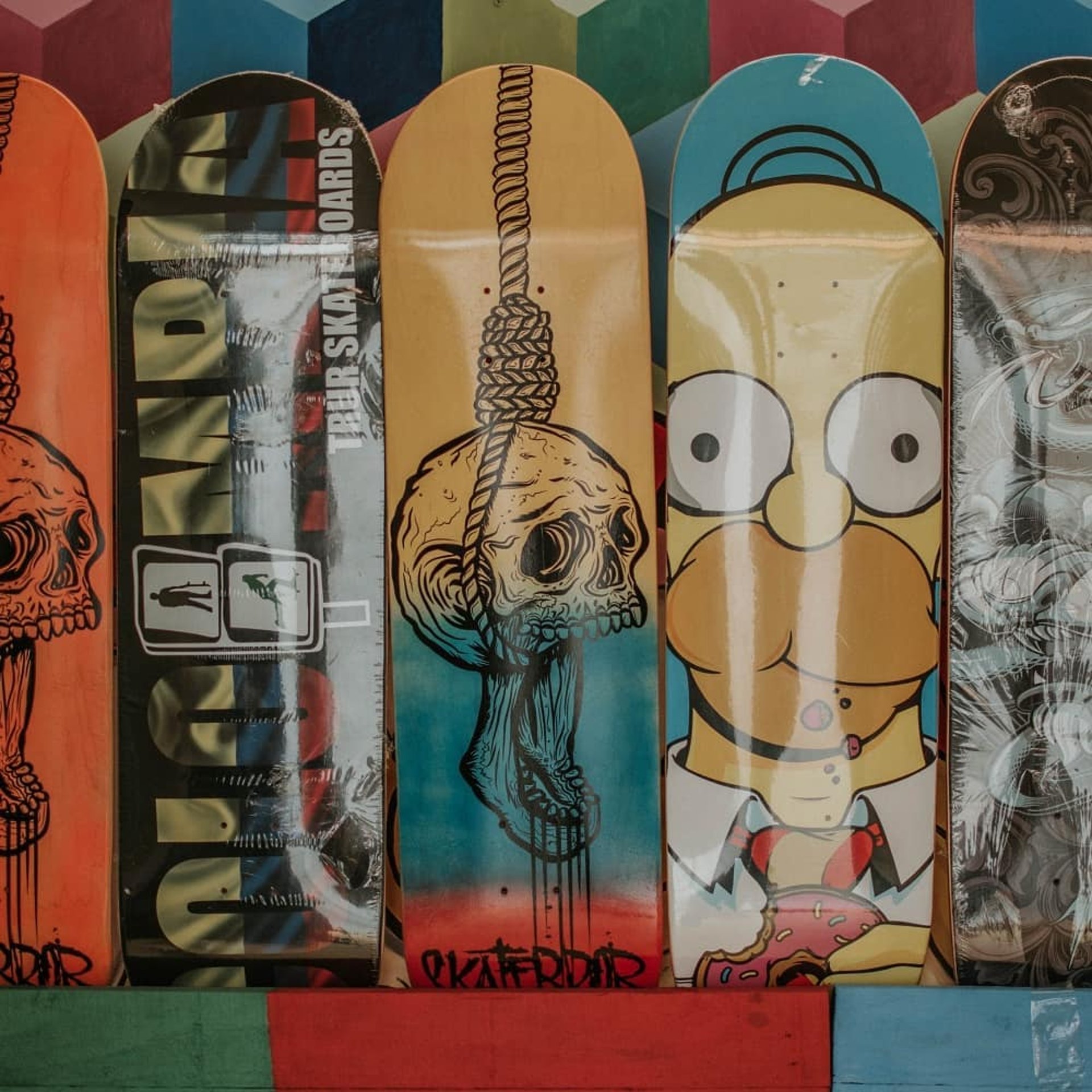 Skateboards and memorabilia displayed on shelves