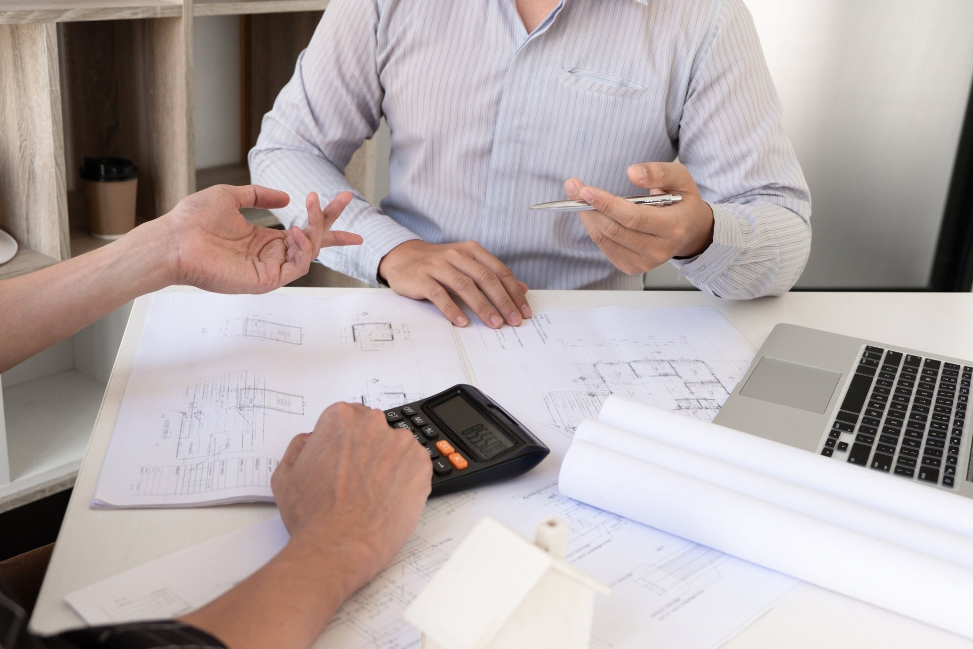 person pointing white paper on wall