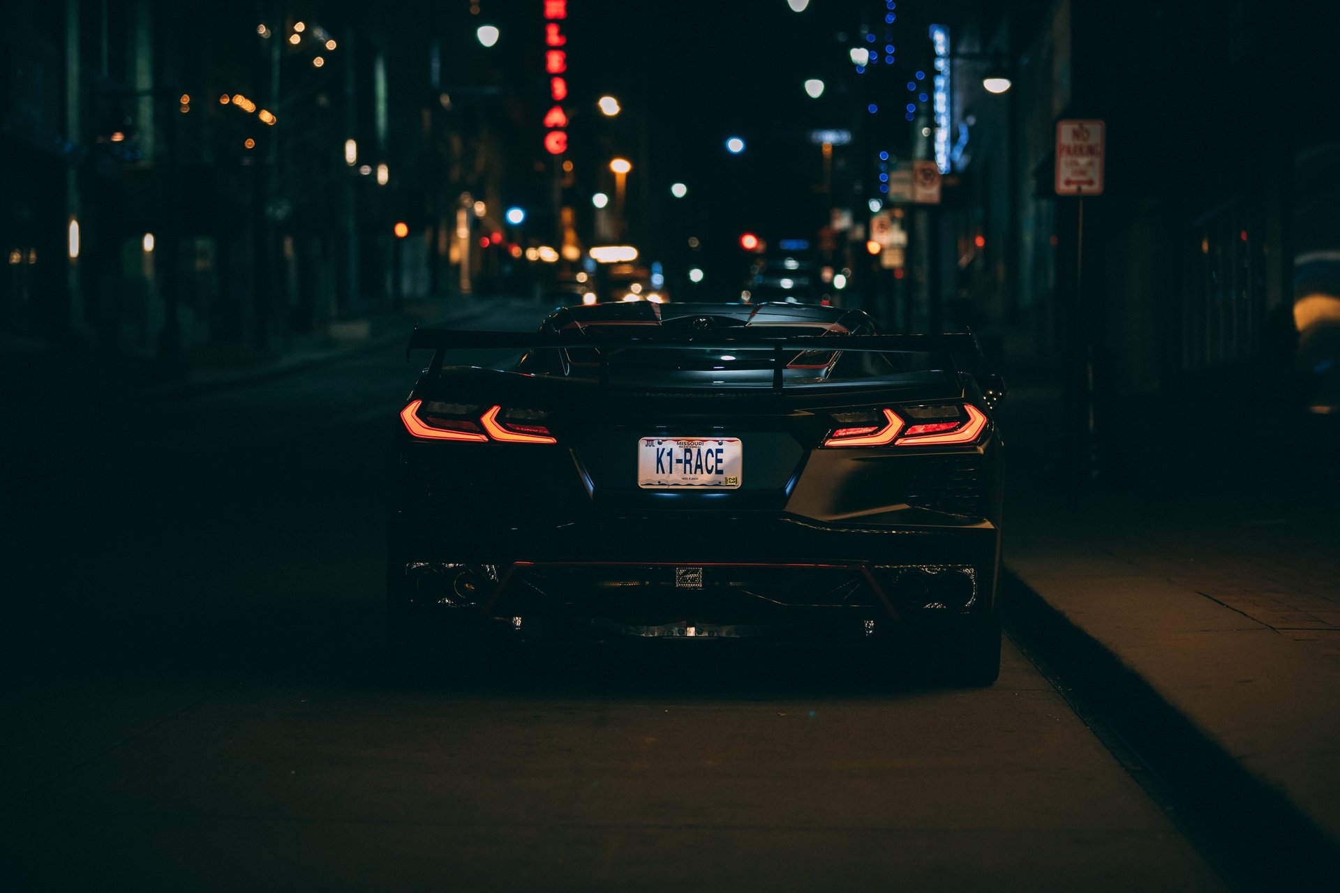woman posing beside lite window