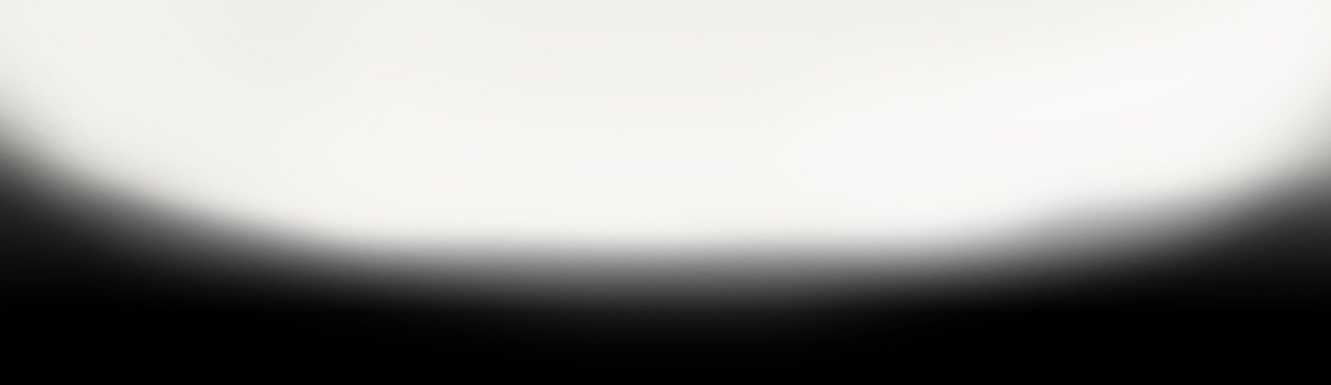 an abstract photo of a curved building with a blue sky in the background