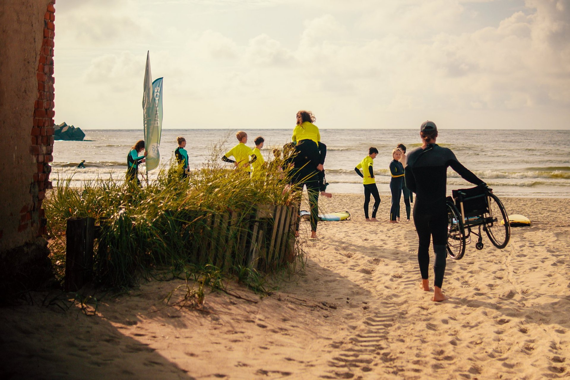 a couple of people holding surfboards on a beach