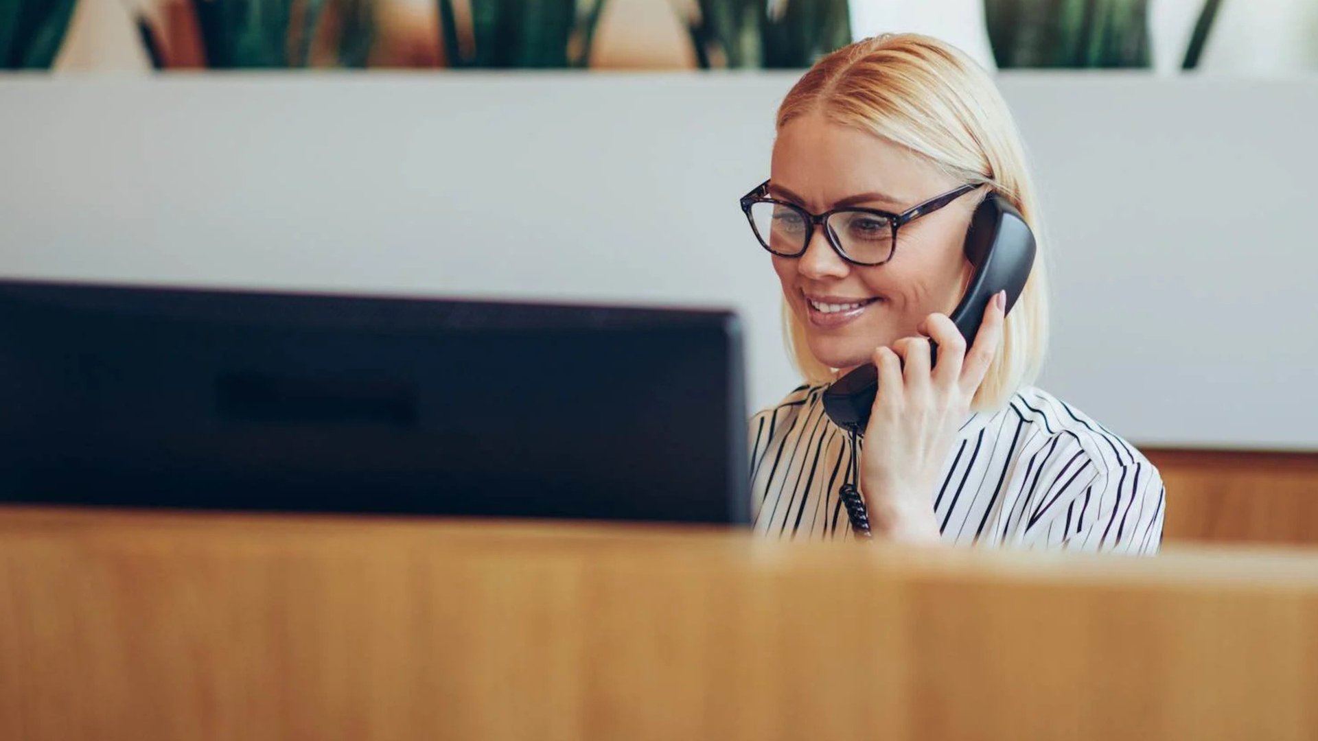 woman sitting around table holding tablet