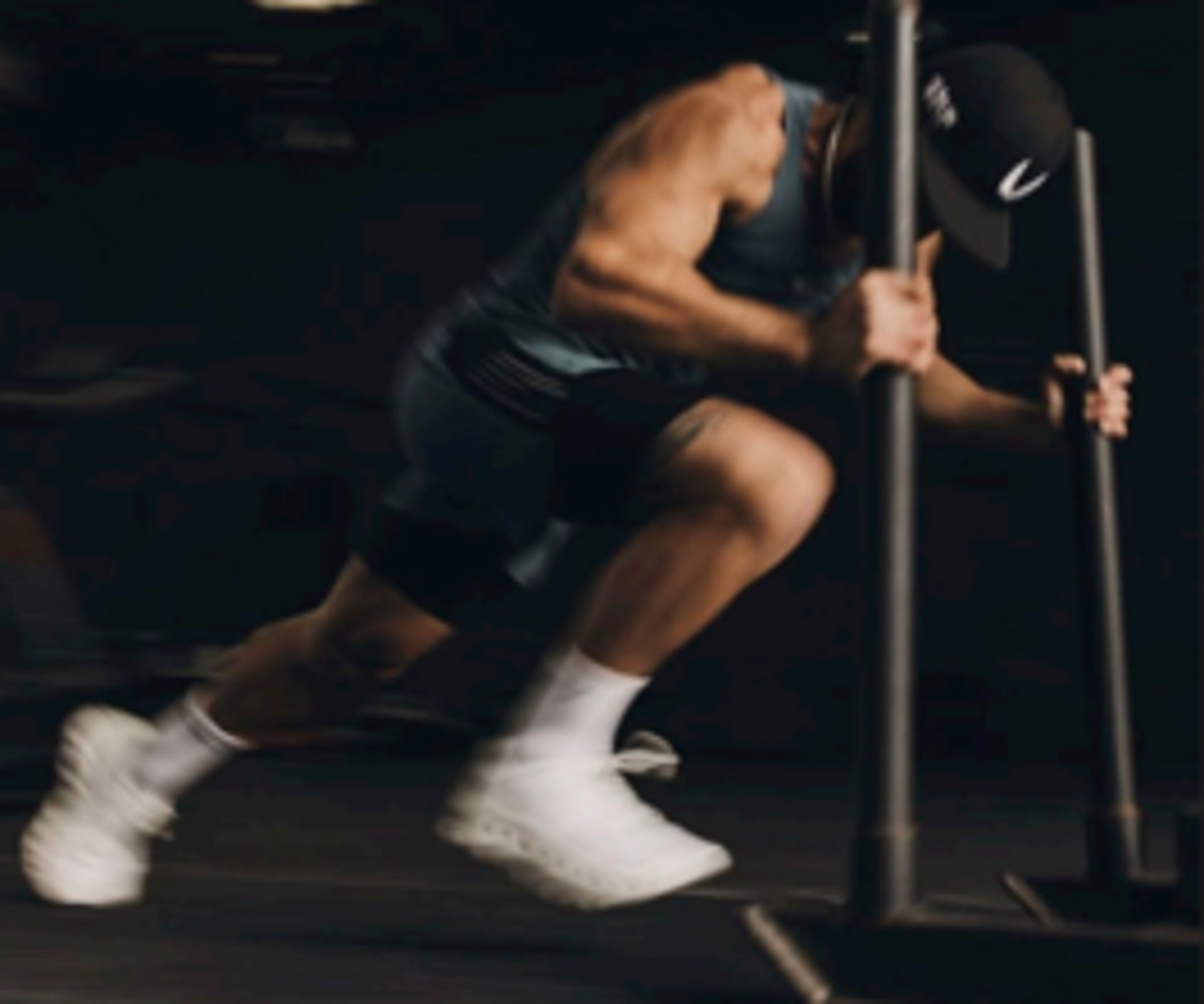 topless man in black shorts sitting on black and silver barbell