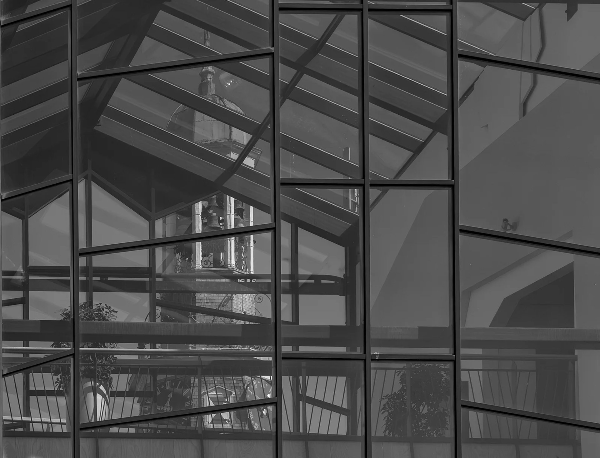 an abstract photo of a curved building with a blue sky in the background