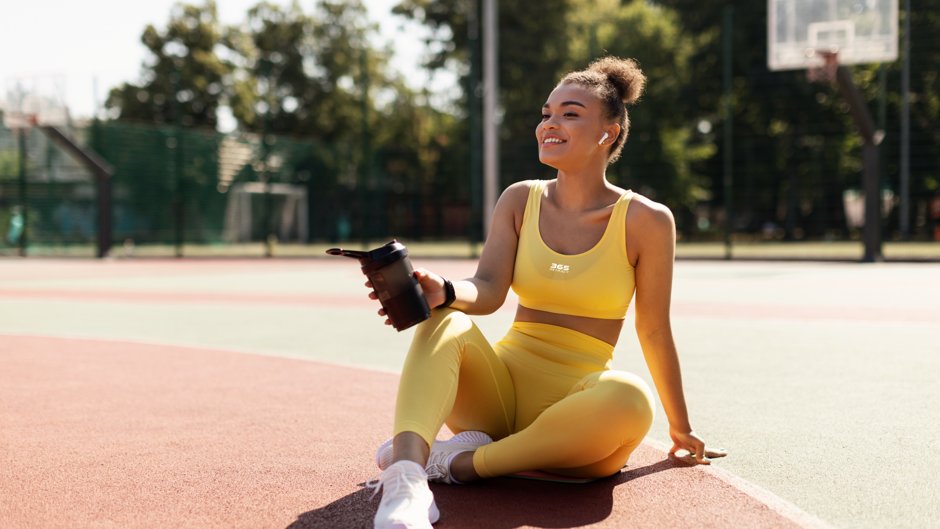 woman in black top holding tennis racket